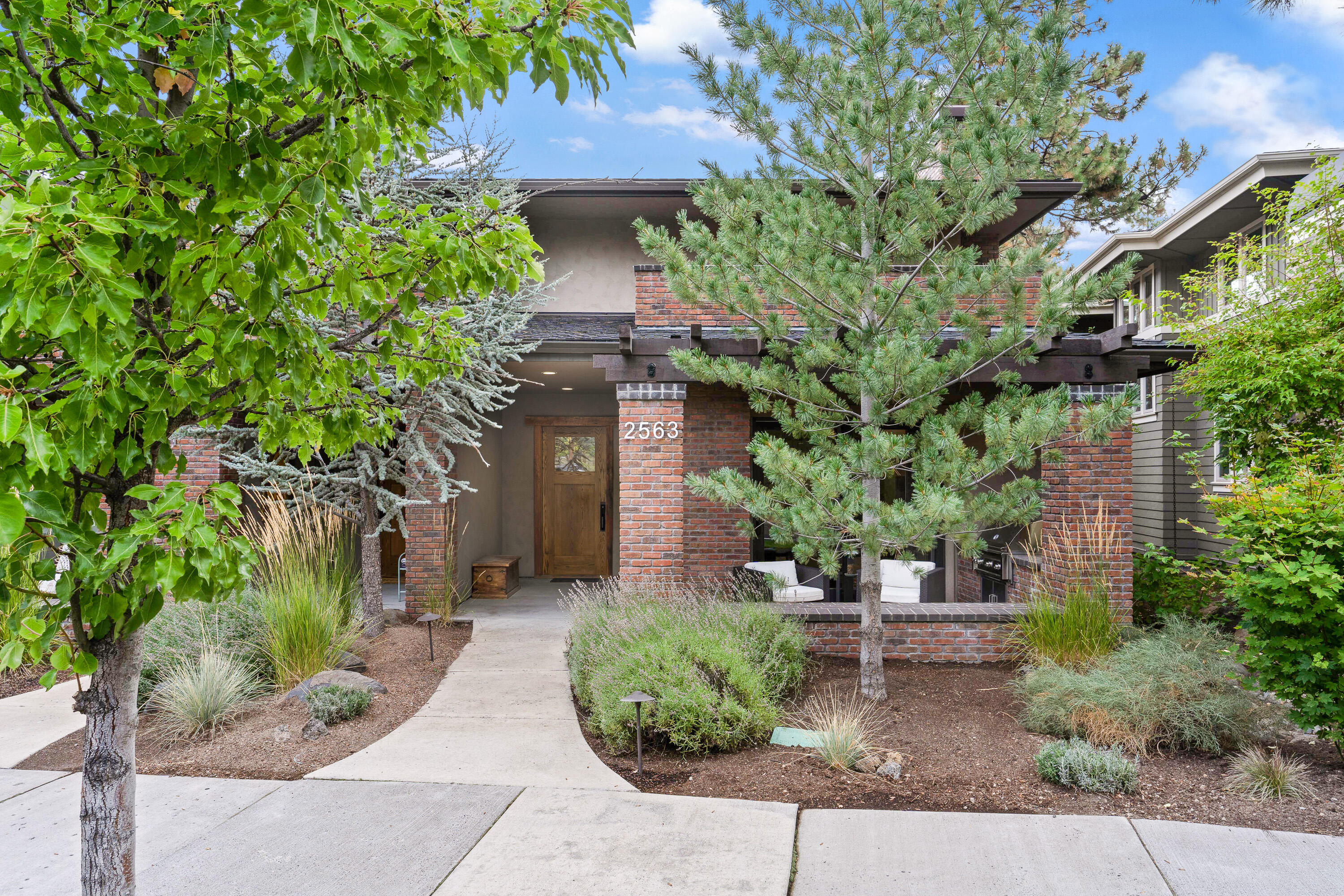 Beautiful NW Contemporary townhome located in the heart of NorthWest Crossing. This home is roomy and comfortable with lots of recent updates. Open and airy floor plan, tall ceilings, large windows and rustic hardwood floors are sure to impress. The well appointed kitchen features honed quartz countertops, Wolf stove top oven with hood, Cove dishwasher, built-in refrigerator and large pantry. Grand primary bedroom that includes with its own private balcony and a beautiful bath with a soaking tub, walk in tile shower and hand painted tile accents. The other 2 bedrooms have ensuite baths and direct access to a private patio that's perfect for entertaining.  Bonus loft/flex space. Integrated smart home system; thermostat, garage doors openers, lighting and doorbell. Outdoor patio with built in Lynx gas grill. Oversized 2 car garage. ICF block construction and brick exterior makes this home solid and efficient. This home is a show stopper, come see it today.