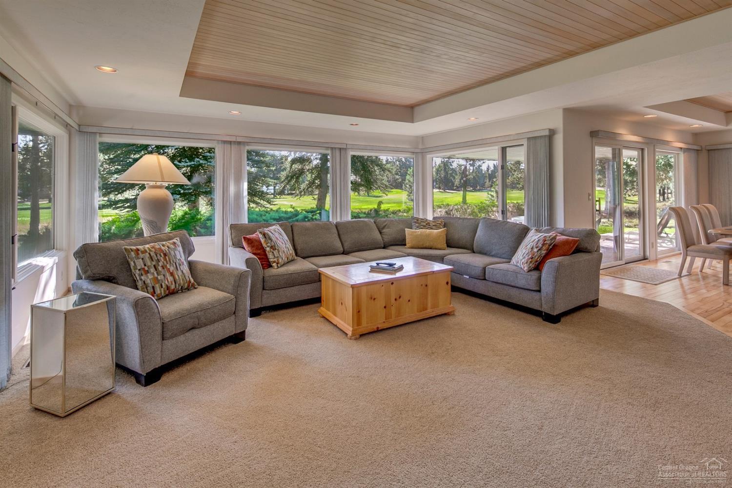 Outstanding opportunity to own a double lot on the Woodland's Golf Course on Winner's Circle. This home boasts a grand entrance w/ double doors opening to a stunning single level home w/ massive windows all w/ views of the fairway. The kitchen is large w/ formal & casual dining areas & a perfect kitchen island. The home was thoughtfully designed to take advantage of nature & natural light. The bedrooms are large & there is room for all. There are three decks, one with an enclosed hot tub. The home is being sold fully furnished. Seller providing $30,000 toward new roof of your choice.