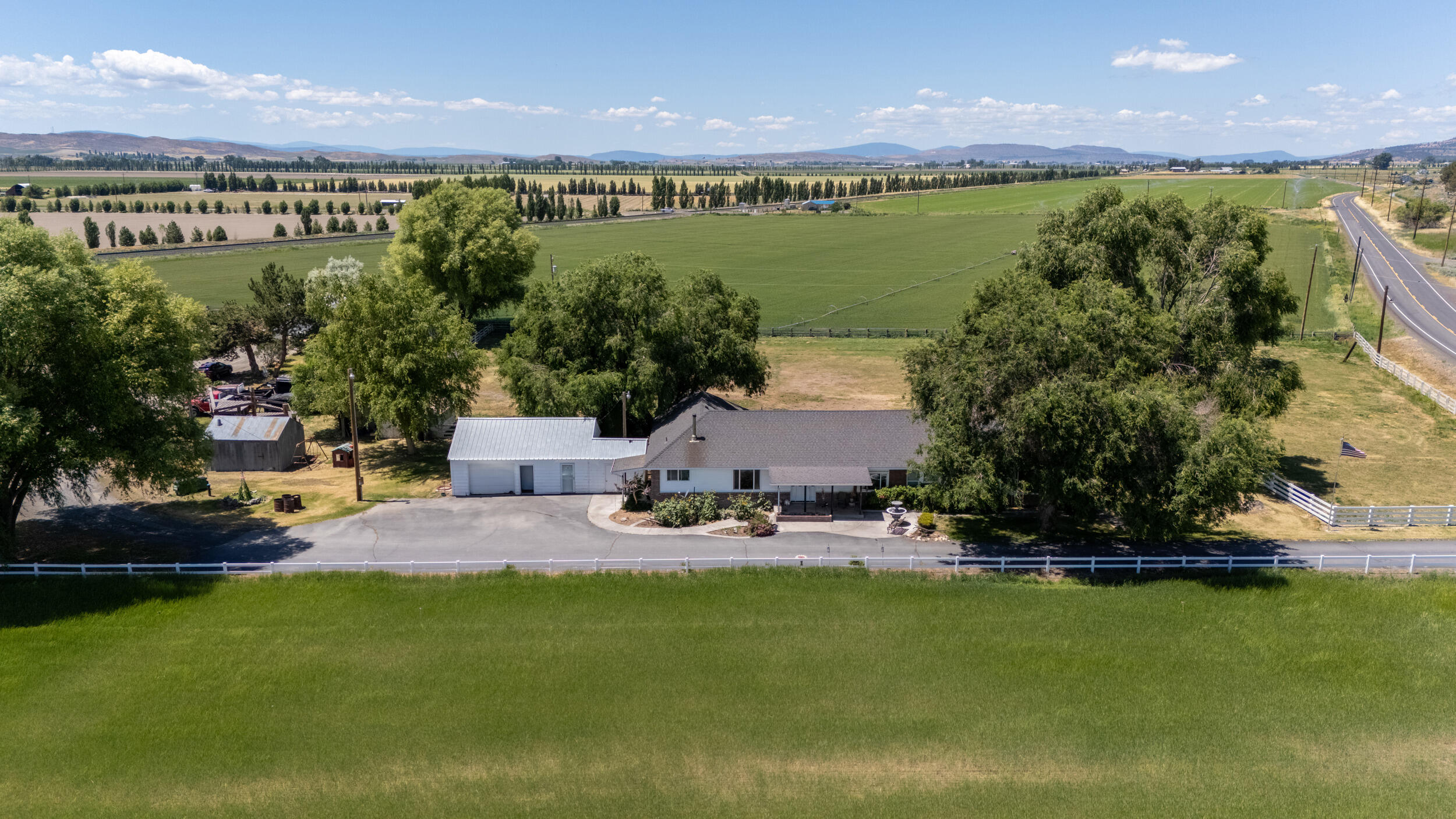 MOTIVATED SELLERS! Bring your hobbies and dreams to this rare 24.79-acre property. Space for your horses, livestock, equipment, and so much more! Established rental income included. This ranch has 23.7 acres of Class A KID irrigation rights. Zoned FR and  located just 5 mi from Merrill. The original ranch-style brick 2,850 SF 4BD/2BA home includes an expansive master suite, wood fireplace, natural oak and marble features. The detached one-car garage offers ample storage space and bonus room. The 1,680 SF ADU manufactured home offers 3BD/2BA with an oversized two-car detached workshop garage and many custom updates. Custom hay barn, with 500-ton capacity with finished railing for options of equestrian use. Large hand-hewn timber barn, corrals, and many other outbuildings. Fully fenced and cross-fenced with a new domestic well, agricultural well, mainline, and wheel lines. Outstanding opportunity with reliable water and fertile soil that once was a lakebed, offering excellent yields.
