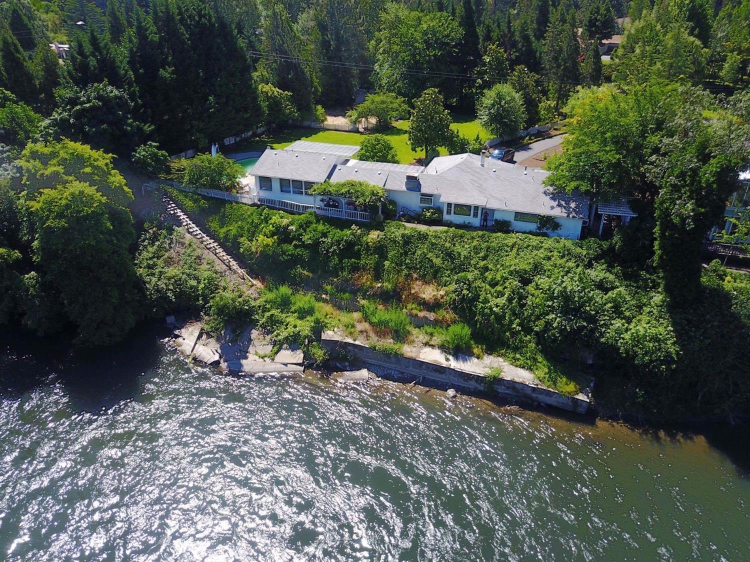 Fly fishing paradise! One of a kind classic cottage style home on the beautiful Rogue River! A hidden Gem! Surrounded by green lawns, decking around the entire home and a large in ground pool with hot tub, this home is perfect for entertaining or just enjoying the peaceful sounds of the river. Main living area has a full kitchen with large master bedroom and luxurious bathroom and smaller half bathroom. Second master bedroom has its own entrance and would be perfect for a guest or pool room. You must see this beautiful home on the Rogue! Please watch the virtual tour of this amazing property! Home is back on the market- no fault of the property!