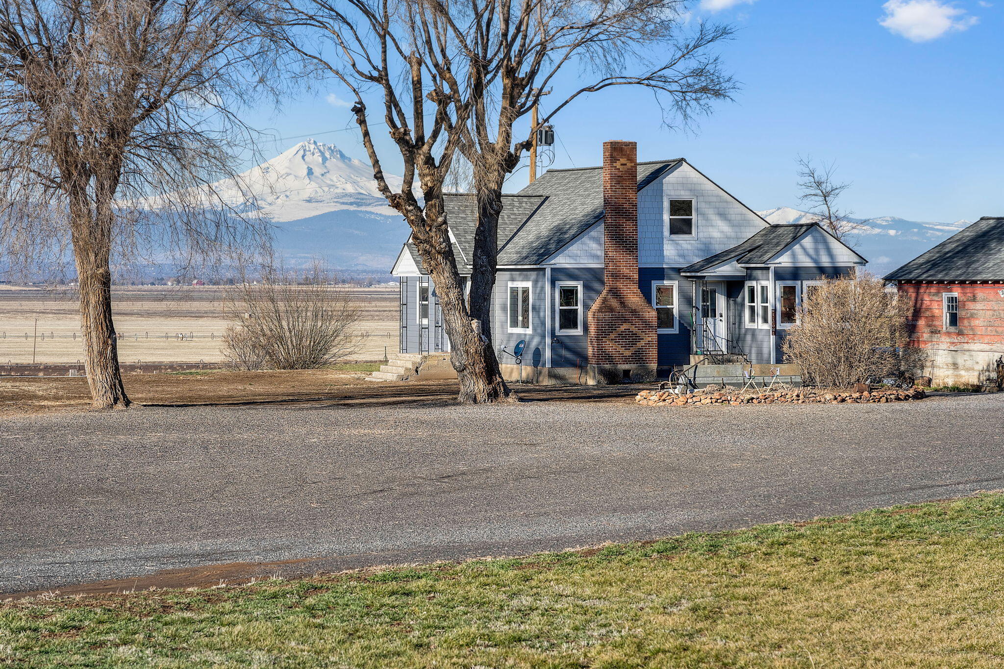 Discover the tranquility of country living on 60.04 acres just outside Culver, Oregon—designed for ease and functionality. With 8.3 acres of irrigation water rights, the land is fully cross-fenced, low-maintenance, and ideal for livestock or hobby farming. A corral, lean-to, and livestock loading area make it ready for immediate use. Take in panoramic Cascade Mountain views from the expansive composite deck, perfect for unwinding or entertaining. The charming 1948 farmhouse offers 1,804 sq ft, 4 bedrooms, 1.5 baths, original hardwood floors, a cozy fireplace, dining room, breakfast nook, and a spacious daylight basement ready for your vision. Recent upgrades include a new roof, siding, exterior paint, and deck. Main level includes 2 bedrooms and full bath, with upstairs offering potential to create a luxurious primary suite. Accessible from both Old Culver Hwy and Hwy 97—this is the ideal blend of space, scenery, and opportunity. Don't miss this exceptional rural retreat.