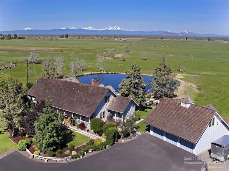 Riggs Road Ranch with Cascade Mountain & Smith Rock Views- 102.9 acres with 100 acres of COI water rights currently used for pasture and hay. Private custom home features: 3611 sq 3 bed/3.5 bath with spacious master suite w/garden tub, office, gourmet kitchen, decks landscaped. Detached 6 car garages (one has finished upstairs for office/game room) Shop with RV storage, Barns, Outdoor Arena, Hay Barn, Corrals & Property is Fenced. Additional 1156 sq ft home-3 bed 2 bath with outbuildings.