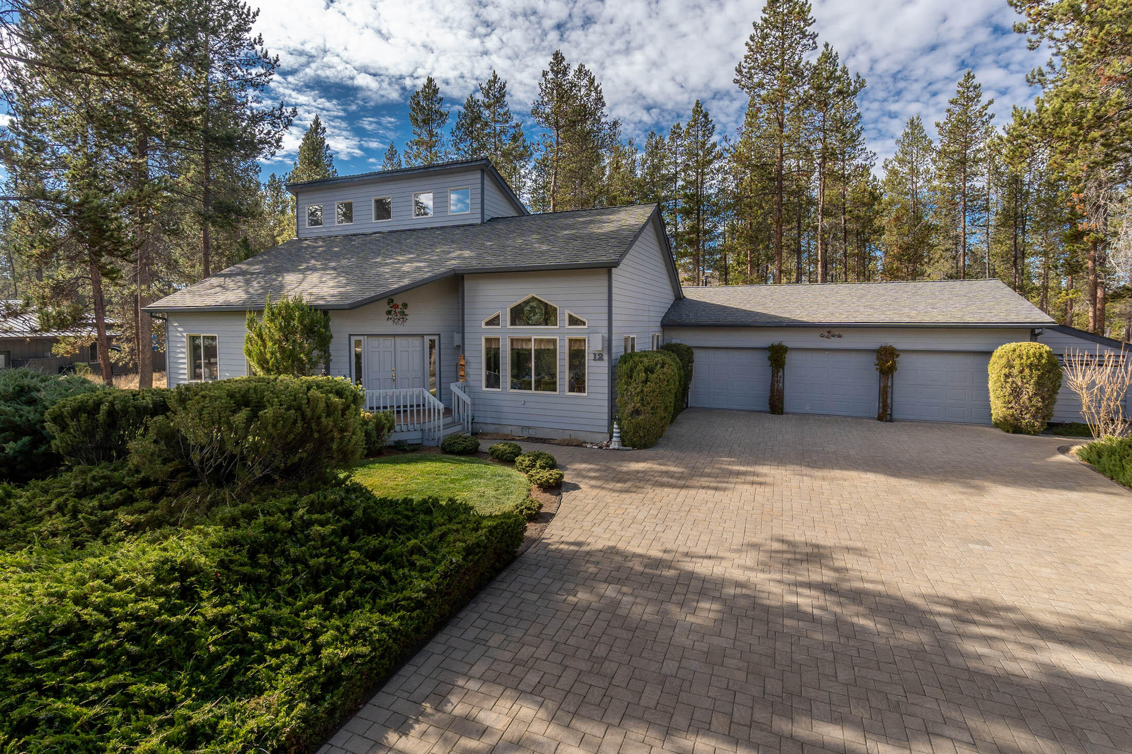 Don't miss this fabulous light and bright comfortable home in North Sunriver. This home has loads of closets and storage. Triple car garage with plenty of extra room to store all your toys , also extra covered storage along side the garage,  also included is 50 amp service to charge your electric  car or hook up for RV . Main bedroom is on the lower level, along with an office or den, 2 bedrooms and a full bath upstairs, and a great loft area for a sitting or desk area. Surround sound d throughout!  Fabulous decks with a nice hot tub.  Surrounded by common area, and just steps to Cottonwood store. Easy to show!