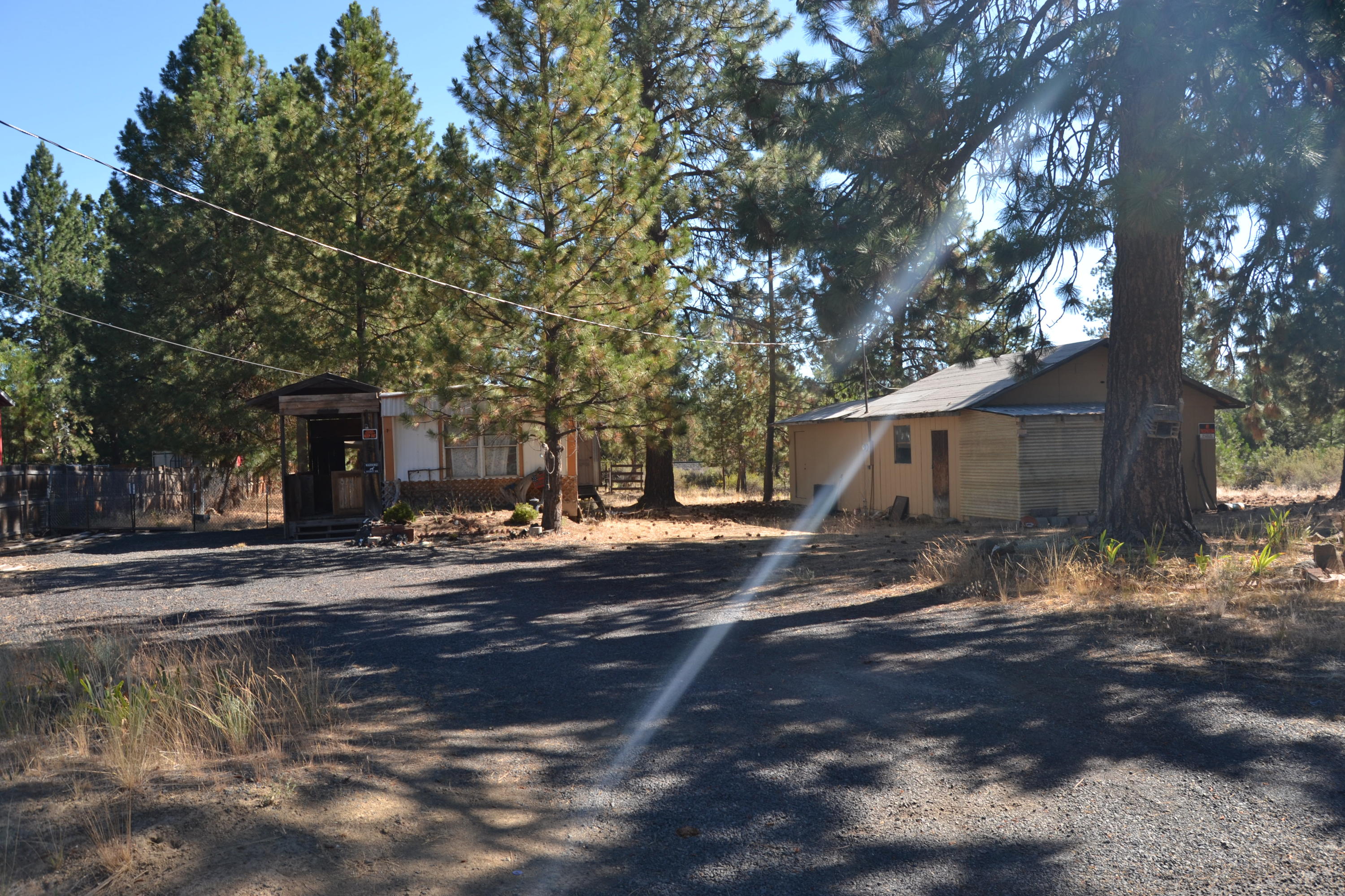 Nice property at the end of a dead-end street. Half acre lot with a manufactured home and detached garage at an affordable price. The value is in the land and is a good opportunity to build a nice home on a private lot in a quiet neighborhood.