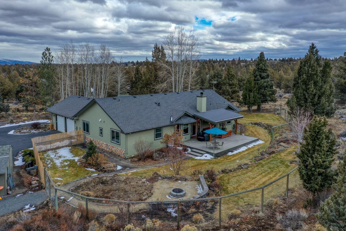 Very private home on just under 5 acres, 2630 Sq. ft single level home with 3 Bedrooms and 2 Baths plus den. Remodeled in 2018 the kitchen was opened to living room with large quartz island, Carrera marble backsplash, built-in Subzero and Thermador appliances and custom Sapele cabinetry with pantry. Large primary bedroom with remodeled bath including Hydro Massage bathtub, walk in shower and two sinks with quartz counters. Good separation between main bedroom and other bedrooms. 704 Sq. ft west-facing paver lanai with sunshade for entertaining, surrounded by beautiful landscaping with 2/3 acre fenced for deer. Grass lawns, native plantings, and glorious annual and perennial flowers. Outdoor firepit and seating area. 2 car attached garage, separate 1200 Sq. ft RV garage with 2, 14' doors and work space. Wood Shed for wood burning fireplace in living room with unique firewood transfer system. Garden shed for tools and storage space big enough for mower, ATV, snow blower, etc.