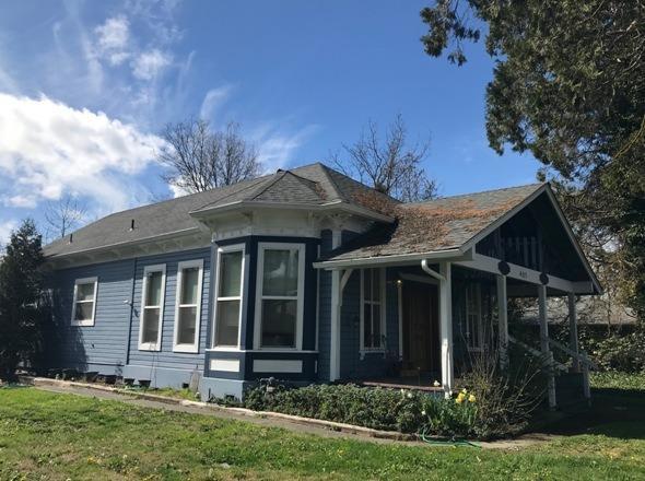 Golden opportunity to live here and let the other two units help pay the mortgage or rent all three! Just over half acre, zoned R-3, in the heart of town. Charming, updated 2 or 3 bedroom, 2 bath features 10' ceilings, remodeled kitchen and bath, heat pump and newer roof. Separate 1BR/1BA unit a studio, recently updated and remodeled. Enjoy the spacious lot with mature fruit trees or make plans to add additional units. Excellent rental history.
