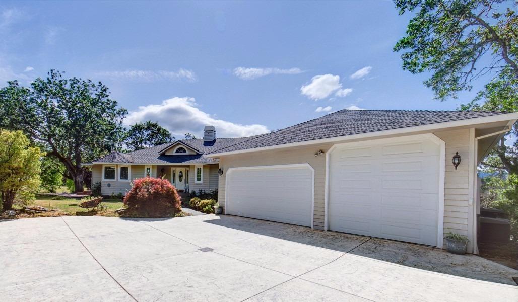 A true tranquil retreat! Beautiful home with views in this 4253 sq ft home on 4.81 parklike acres. Completely updated in 2008. Home features 4 bdrm, 3 ba. The Master suite and kitchen are exquisite. Lg Master 2 lg walk-in closets, gas frpl, attached office/exercise rm. Lg Kitchen w/walk-in pantry, granite counters, extra lg center island w/sink & disposal. High end appliances, beautiful cabinetry, bay window, skylight. Recessed lighting & insta hot throughout. Central vac, 3 AC/heating units, Lg decks w/BBQ hkups. Lg laundry rm & washer/dryer. Open floor plan, high ceilings, w/hardwood, travertine, tile & carpet. Living rm W/Gas/wood frpl, lg wood mantel/granite hearth. Lower level: media/rec rm W/pool table, bdrm & ba, lg workshop & attached garage. 2 high producing wells, tractor, 2 gates w/openers/codes. Main: attached 3 car garage, 1 w/ RV door. 2.5 irrigated acres w/inground sprinklers, 1 acre fenced corral, dog run, seasonal creek, fish pond, gas firepit, STORAGE GALORE & MORE!