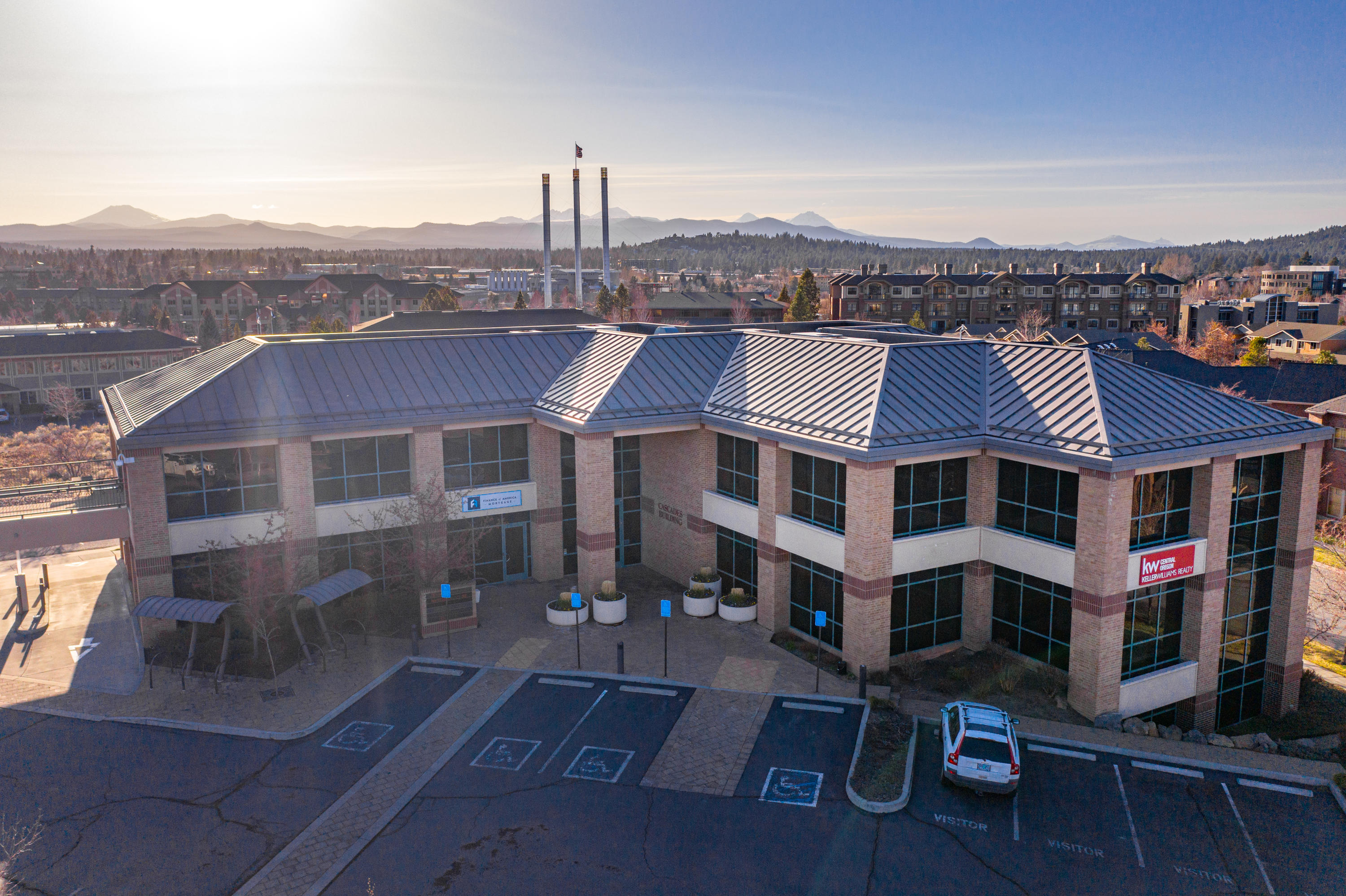The Cascades Building is one of Bend, Oregon's premier Class A office buildings. Built in 2003 with steel framing, brick masonry and a metal roof, the building is comprised of 20,456 square feet of office space on three floors. Interior improvements
include an attractive lobby area, twelve finished suites with high-end finishes and elevator access to every floor. The building also has two covered drive-thru lanes that were previously used by First Interstate Bank.

The suite sizes range from 213 square feet to 5,775 square feet. Most suites feature large floor-to-ceiling windows providing plenty of natural light and mountain views.

The building's prominent location in the Old Mill District on the Bond & Wilson roundabout provides excellent visibility and easy access to and from downtown Bend and Highway 97. The location also provides tenants with easy access to the surrounding restaurants, shops and river trail along the Deschutes River.

Contact brokers for Offering Memorandum.