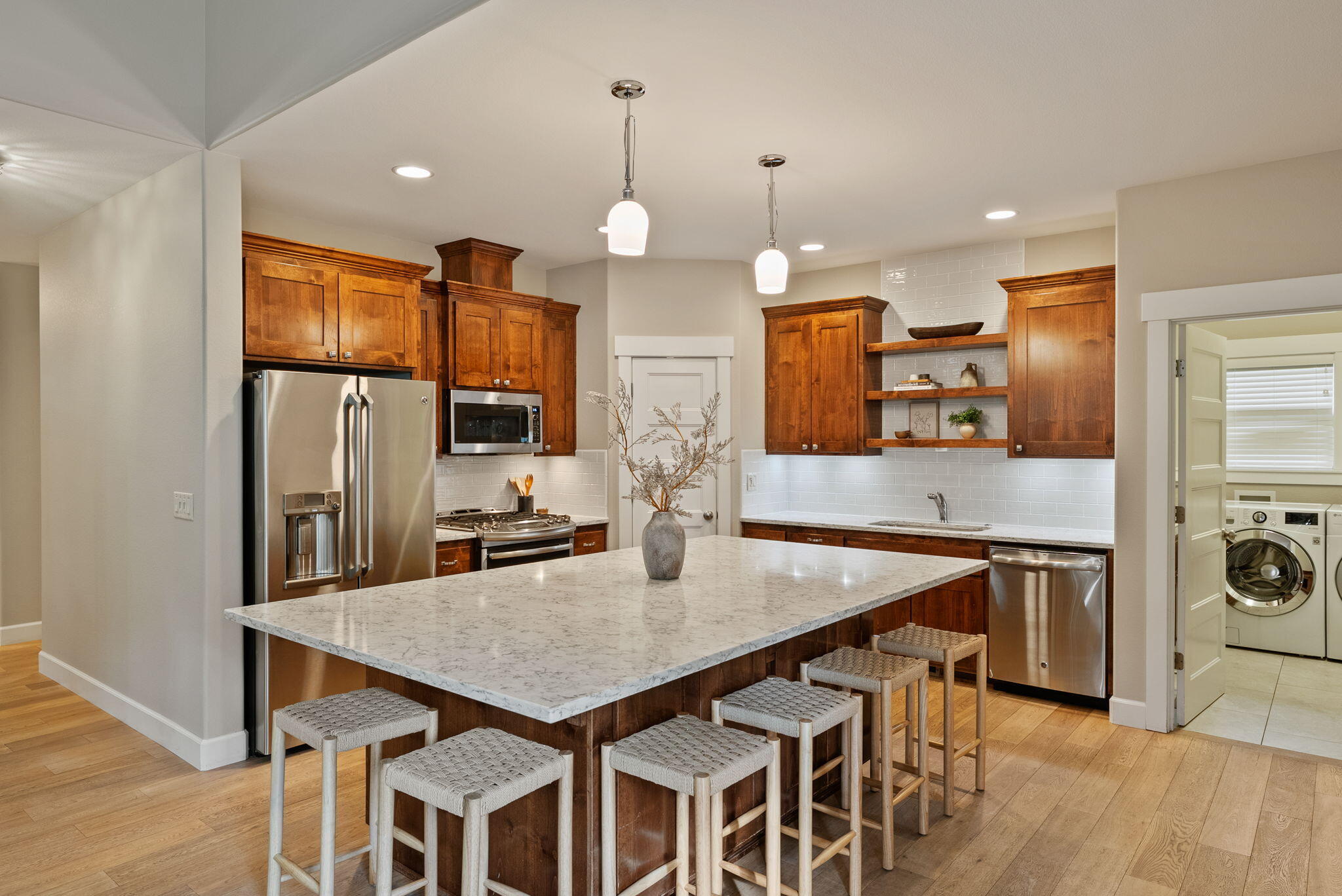 Welcome to this Northwest Crossing gem, where Craftsman charm meets modern comfort. This 4-bedroom plus office/bonus room home features a main-level primary suite with a spa-like bath, soaking tub, and full tile shower. The open great room showcases vaulted ceilings and abundant natural light, while the chef's kitchen impresses with a quartz island seating eight—ideal for casual dining or entertaining. A downstairs bonus room/office with a Murphy bed and custom cabinetry by California Closets offers flexible living. Hardwood floors add warmth throughout the main level, and upstairs you'll find three spacious bedrooms and a full bath. Outside, enjoy a fully fenced backyard with a greenhouse and shed, plus solar panels for energy efficiency. Perched on an elevated lot with a charming covered front porch, this home delivers the best of NW Crossing living—schedule your private showing today!