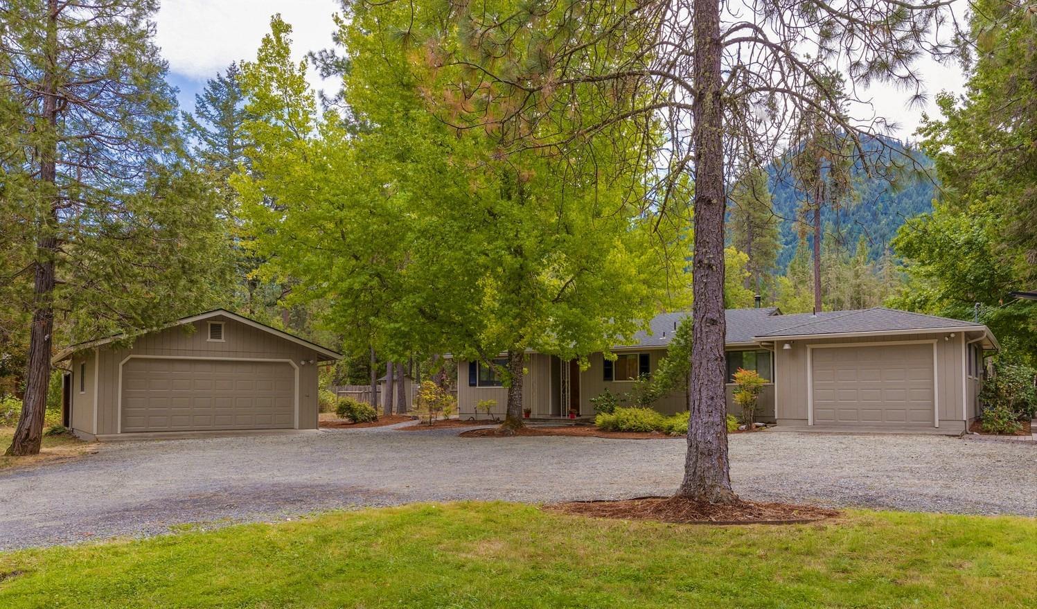 Your next home is located in the country with 2.1 acres of space, clean air, nature, delicious apple & pear trees, a 1 car garage AND shop (2 car detached garage) w/220V. The perfectly sized single level home is 1554 SF with 3 BR/2BA and features: light & bright rooms, hardwood flooring throughout, canned lighting & granite kitchen counter tops with custom tile accents, a wood stove for efficient heating & new carpet in the Master & 2nd Bedrooms! This great property offer's the perfect combination of features & location. The home has been treated well, with new paint inside & out plus fresh bark! There is room for your RV, or your guests RV! The backyard has a wonderful little pond with Koi Aplenty! Luxuriate in the Hot Tub while enjoying mountain views. The pasture is perfect for horses! You're in the country so you'll need the shed & wood storage provided, the great shop w/back room plus the wrap-around low to ground cedar deck to access everything! Call it home today!