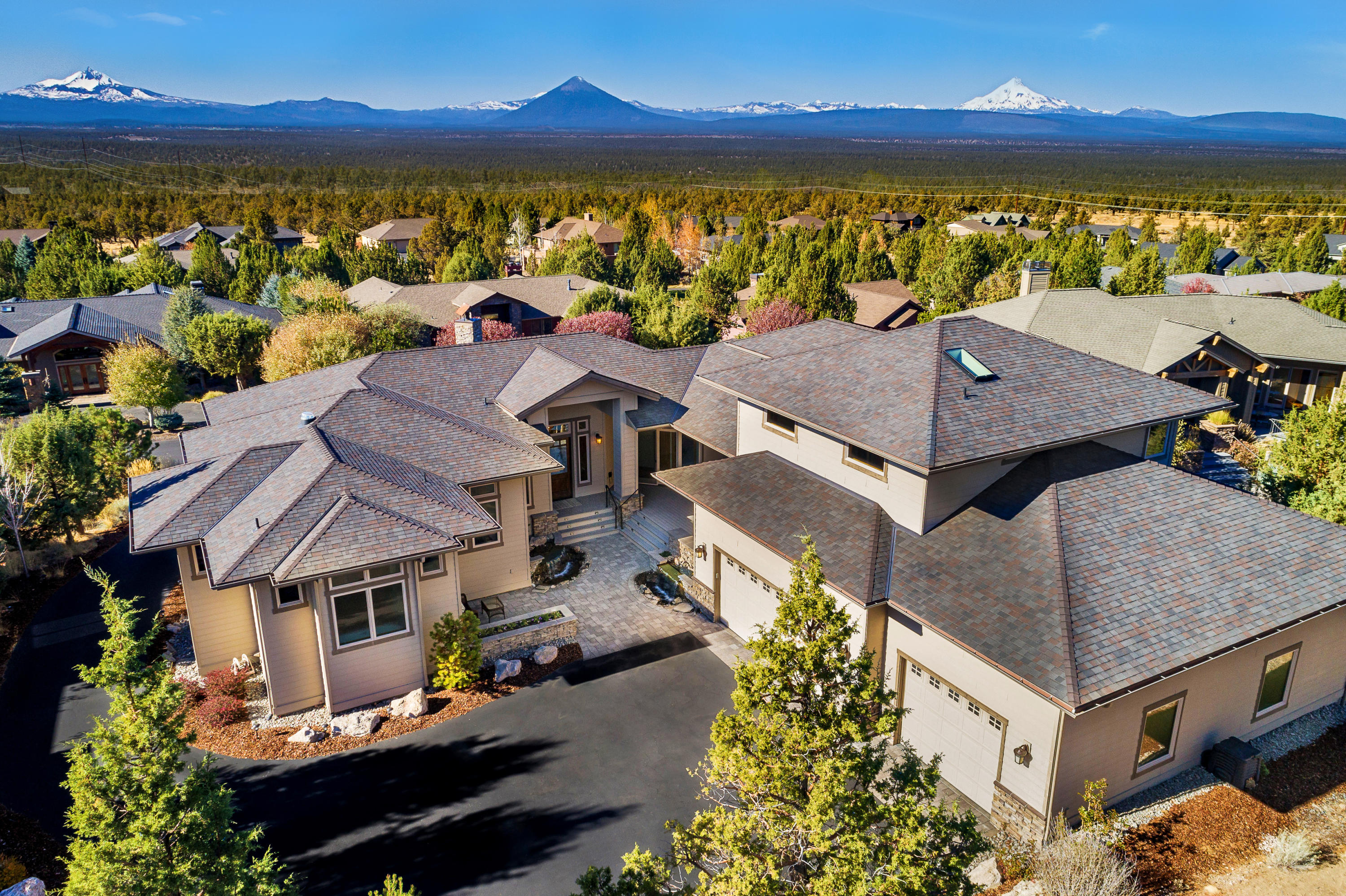 Magnificent home with Cascade Mountain views features 11' ceilings & open floorplan sure to please the entertainers' lifestyle. Every detail of this home exudes excellence. Wood wrapped windows, 8' solid wood doors, acid-washed slab granite, knotty oak floors, stacked stone fireplace. Main-level master suite, huge closet,
stacked washer/ dryer, soaking tub, separate shower, heated floors. Main level includes office/DR, guest room, full and half baths, and second laundry. Upstairs bonus room with mini kitchen, library and ensuite guest room is perfect for visiting family or friends. For those car buffs, a tandem SIX CAR (or more)  garage with 14' ceilings, epoxy
floor, heated, finished walls, sound system, workshop area, storage. Wrap around deck provides ample areas to enjoy the views. Double-insulated exterior walls. Privacy ensured with front door and garage entrance facing away from street. Front patio offers water features and built-in gas grill. Level lot backs to common area.