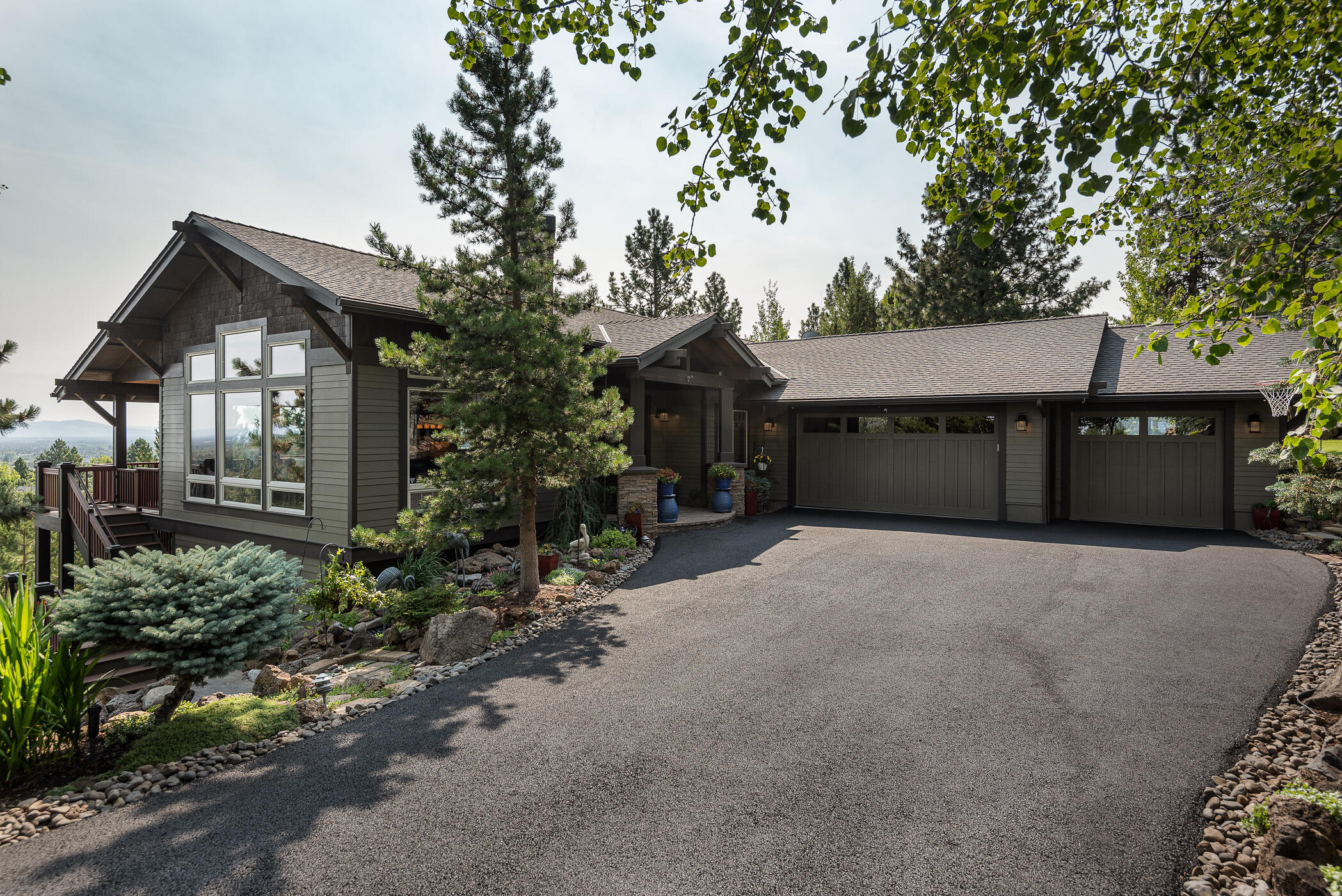 Enjoy panoramic Cascade Mtn. to Ochoco Mtn. views from this beautiful Awbrey Park home. Decks on both levels, flagstone patio, yard space, play structure area (or bocce ball court?) and putting green create the perfect outdoor lifestyle. The new walnut flooring is gorgeous, from the open great room to the main floor primary suite. Casual dining adjacent to the kitchen, plus island seating and a bar make meals and entertaining easy. Downstairs is the bonus room, theater, climate controlled wine cellar, fitness room, and 3 bedrooms. A shed/workshop is attached to the oversized 3-car garage. Fenced dog run, invisible fence, and an idyllic Bend, OR west side neighborhood ... this home has it all!