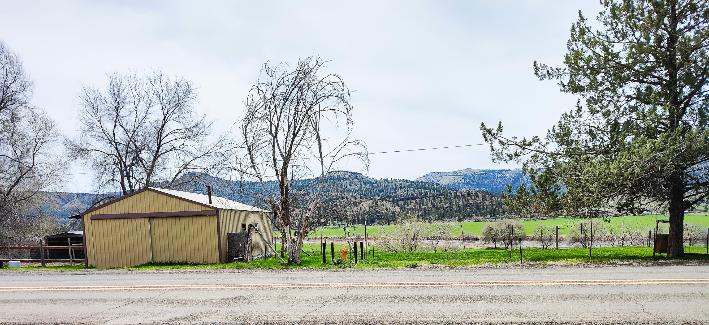 Motivated sellers are offering this beautiful lot with river views, all utilites to the lot, has a shop, animal building, it's fenced and cross fenced.  .93 of an acre.  Build your dream home.