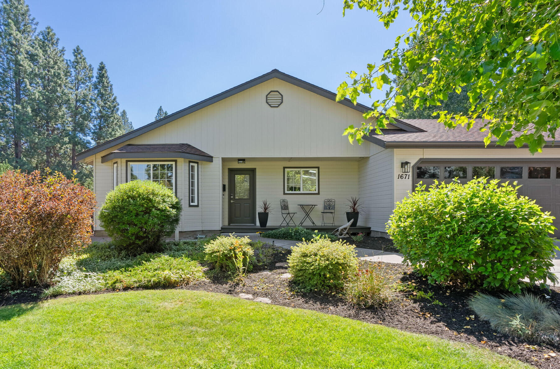 Tucked back on a private 0.33-acre lot in Midtown Bend, this single-level home offers privacy, charm, and space to live the Bend lifestyle. A landscaped front yard and long driveway lead to a large RV pad with 30-amp power and sewer hookup, ideal for all your toys and travel needs. The expansive lot is designed for projects and play with a workshop featuring built-in benches and 220V power, a shed perfectly sized for tools and gear, and a greenhouse tucked beside the vegetable garden just off the sunny back patio. Inside, the home feels fresh and inviting with new paint, updated fixtures, and thoughtful care throughout. The spacious primary suite includes a walk-in closet and large bath with step-in shower, while both bathrooms feature heated floors for year-round comfort. With its generous outdoor amenities, versatile spaces, and central location near Al Moody Park and Stover Ball Field & Playground, this home blends function, lifestyle, and true Bend living.