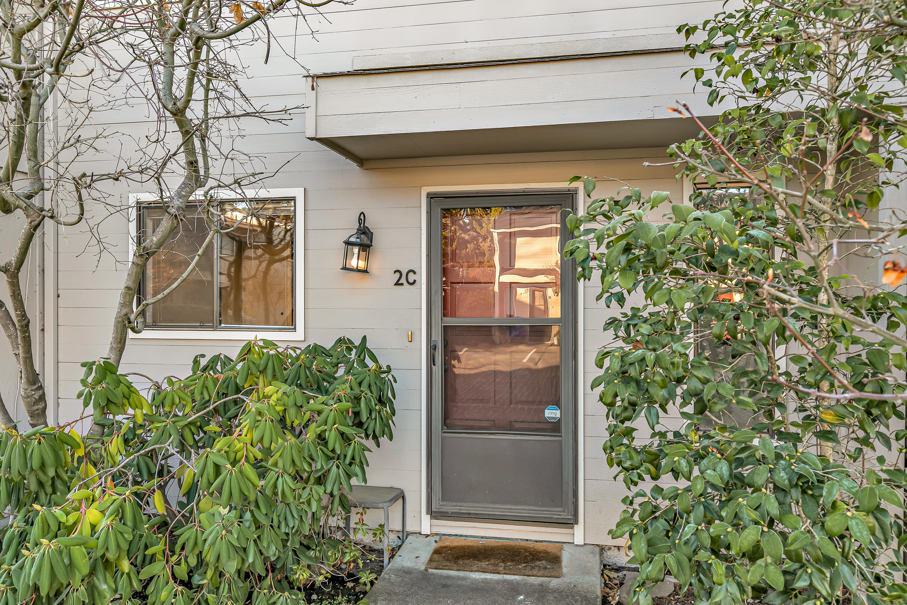 Affordable, charming East Medford end-unit townhome offering privacy, natural light, and convenience. Nestled in a quiet, low-traffic neighborhood, this home is just a short walk to Bear Creek Park and minutes from shopping and dining. Inside, you'll find two bedrooms and two baths, a cozy wood-burning fireplace with antique mantle, and the only unit featuring a center kitchen. Thoughtfully upgraded in 2021, the kitchen boasts granite counters, new sink fixtures, modern appliances, and fresh flooring throughout. Upstairs, two generously sized bedrooms await, including a primary suite with its own private deck overlooking the large, fenced yard. Upstairs bathroom tiled for timeless appeal. With only one shared wall, this end unit enjoys extra privacy and light. Outside, relax on the back patio with its inviting porch swing and enjoy the rare benefit of your own backyard in a low-maintenance setting. Truly a hidden gem in East Medford.