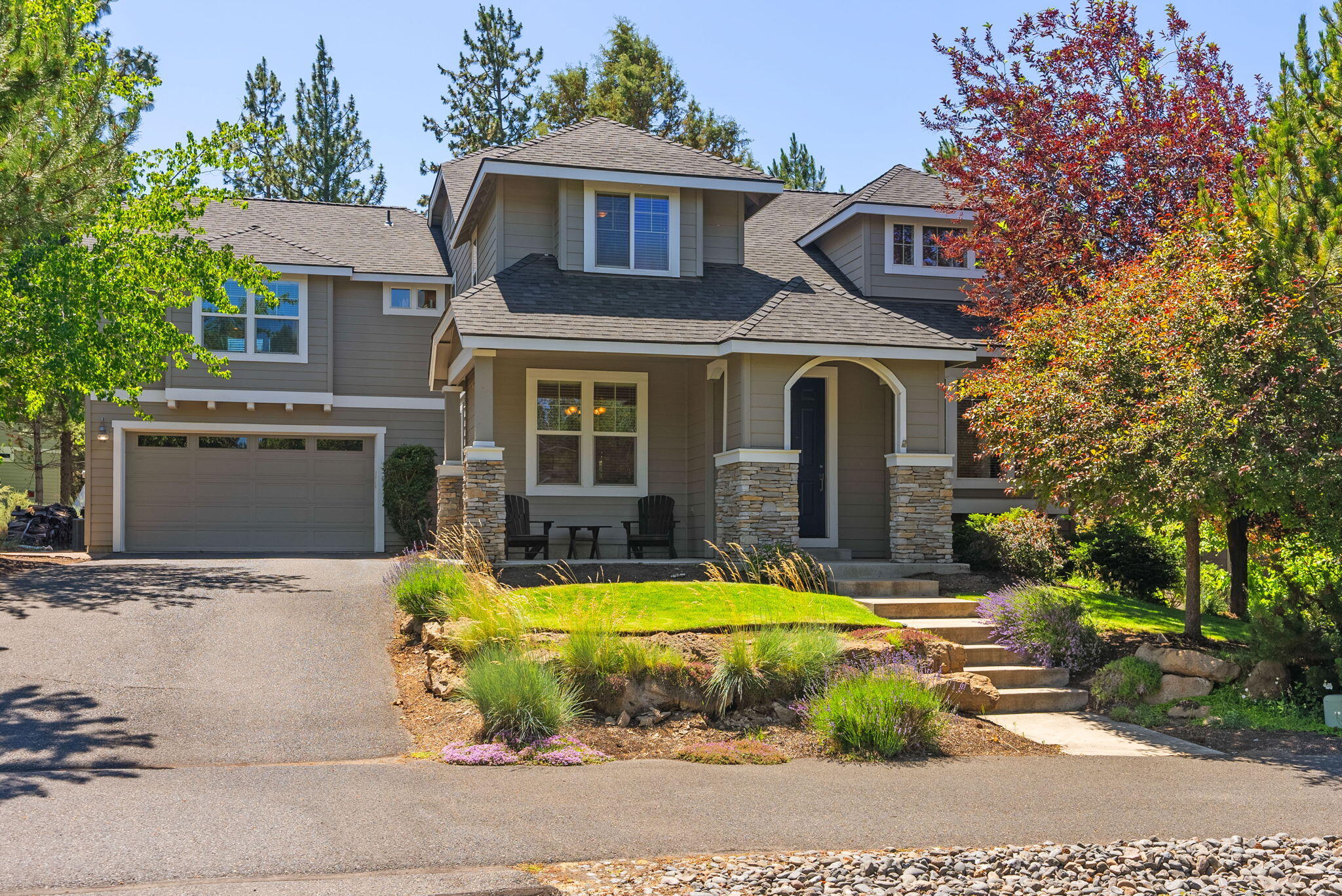 Set on a large .29 acre lot in the Parks neighborhood, this beautifully maintained, single-owner, home offers space, privacy, and peek-a-boo Cascade Mountain views. Backing to protected open space and surrounded by mature landscaping, the setting feels peaceful and secluded—yet you're still close to everything Bend has to offer. 
Inside, the main level features hardwood floors, a formal dining room perfect for hosting, and kitchen with brand-new appliances. Upstairs, the spacious primary suite includes a private deck, while two additional bedrooms and a full bath complete the main wing. A separate back staircase leads to a generous bunkhouse above the garage. Features included: built-in cabinetry, private deck, an attached bedroom and full bath, perfect for guests or multi-generational living.
Enjoy brand-new decks completed in June 2025, and take full advantage of the neighborhood's scenic trails, open spaces, and community pool.