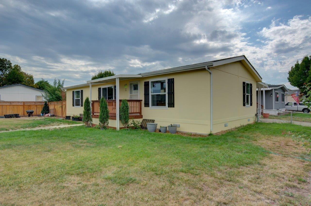 Well maintained 3 Bed/2 Bath, 2014 Manufactured Home located in Butte Crest Park! This home is fenced which provides seclusion and privacy on a spacious corner lot. Covered custom deck along front of home is perfect for gathering with family and friends. The 1248 sq ft home has a split floor plan with a walk in closet in the Master. Chamberlain Park is located just a few blocks away. All appliances are included. Vaulted ceilings, vinyl windows, covered carport, and storage shed. Come see this home today!