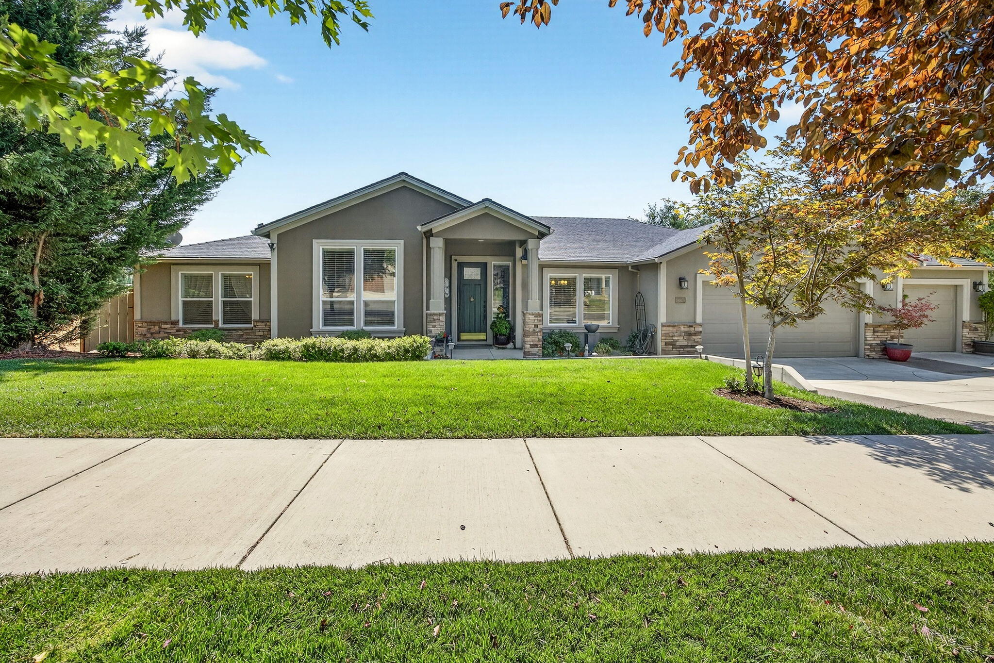 Beautiful East Hills single level home with nice views of Southern Mts and Rogue Valley. Backs up to seasonal creek. Custom built for owners w/extra amenities added. Great open floor plan w/4 bdrms, lg great rm w/a stunning gas log fireplace w/built in bookcases. French doors to a covered deck. Amazing lg kitchen w/2 pantries, granite counters w/island, gas cooktop w/built in wall oven, microwave & refrigerator. Primary suite w/ granite counters, water closet, lg tile shower and walk in closet.  Good storage in laundry rm w/washer, dryer and granite counters.  Many wide plank wood floors. Stucco exterior w/rock in front yard. Oversized 3 car finished garage w/shelves work bench + another shop/storage rm under the house with 2nd patio w/pavers to a beautiful fenced backyard w/fruit trees, night lighting and shed.