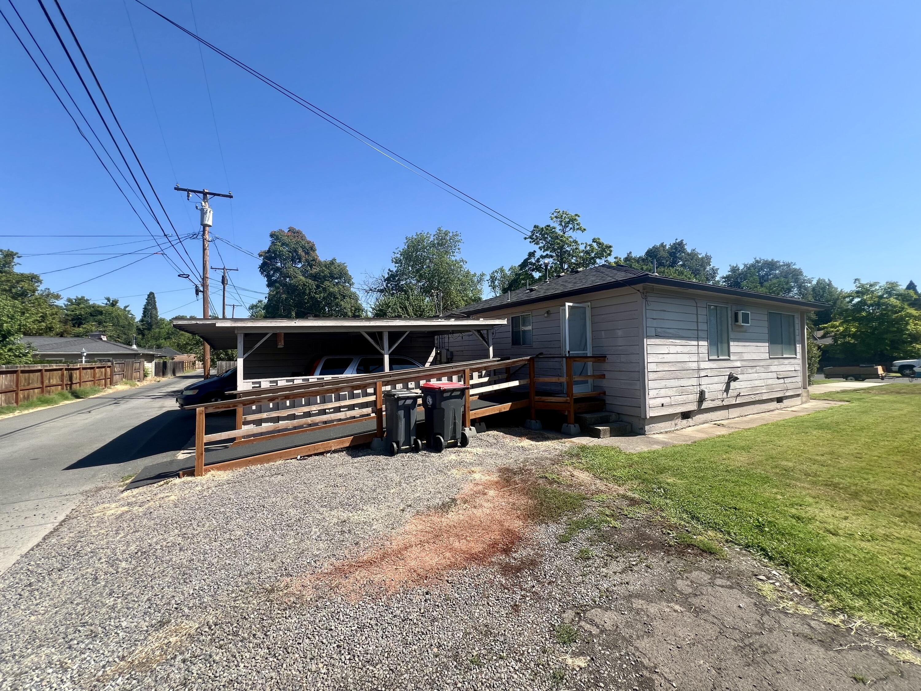 Well-maintained 1957 duplex in a quiet Medford neighborhood, offering two 2BD/1BA units with single-car carports off a private back alley. Totaling 1,820 SF, the property features separate gas/power meters, no HOA fees, professional management, and attractive landscaping. Unit #1 includes a wheelchair-accessible ramp; tenants in place since Jan 2023 and May 2011, each paying $1,295/month. Convenient to Jackson Elementary, Hawthorne Park, and downtown Medford. A turnkey investment with long-term rental stability.