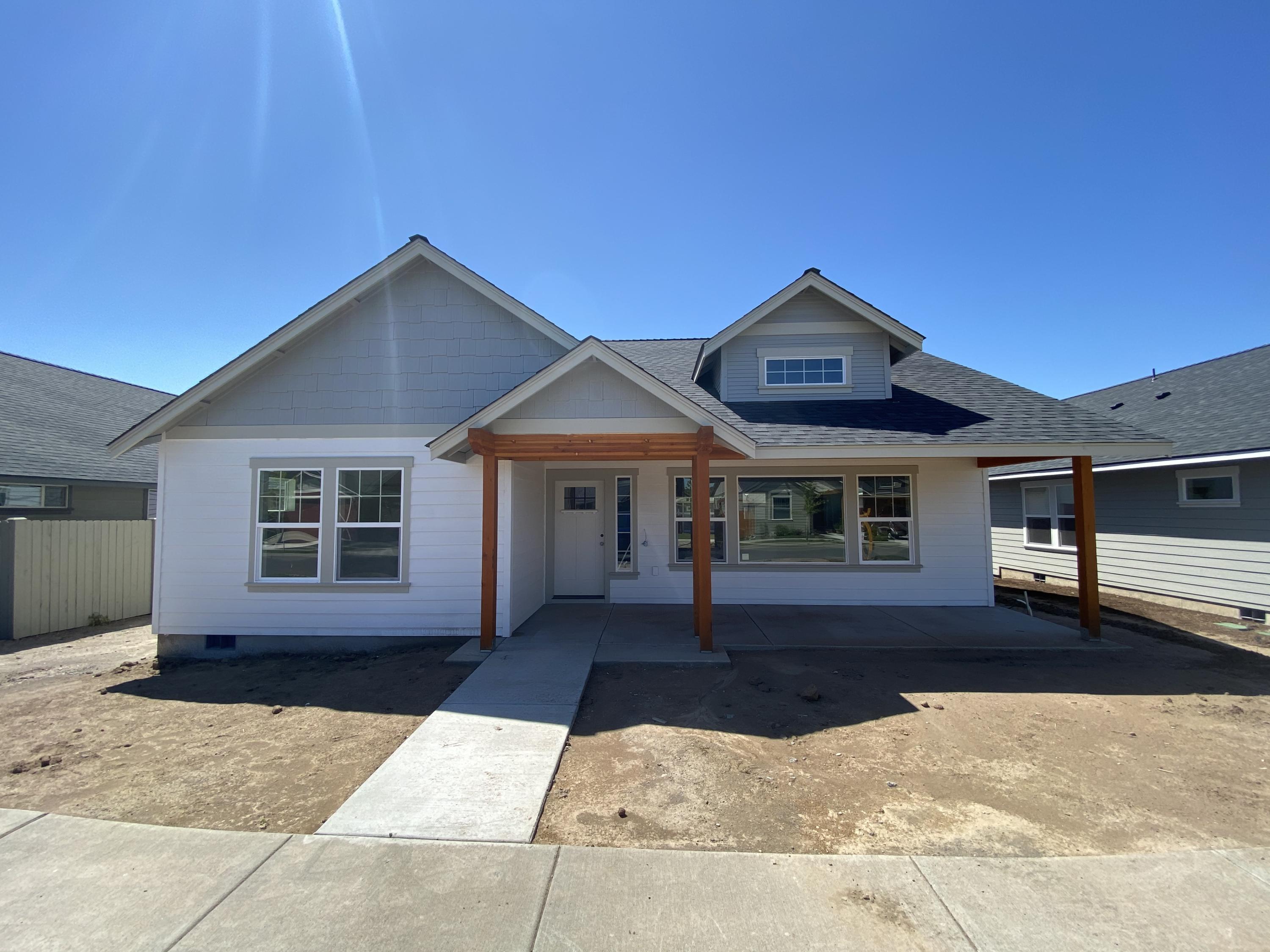 Just about completed! Stunning new custom single level energy efficient Earth Advantage certified home in the desirable Ironhorse neighborhood! Home features an expansive great room floorplan w/huge vaulted ceiling, beautiful contemporary interior finishes including white painted cabinets w/granite slab counter tops & full height tile backsplash in the nicely situated kitchen w/huge island & bar seating, SS appliances, beautiful laminate wood floors in living area w/inviting stacked stone fireplace & tv nook, carpet in bedrooms, & an amazing laundry/mud room!  The vaulted master features a spacious walk in closet, double vanity w/granite counters, & large tiled shower. Beautiful front & rear landscaping w/sprinkler system, fenced backyard, RV Parking Option, Barnes Butte Views, & huge covered front/rear patios perfect for entertaining. Great location close to Barnes Butte Trailhead, parks, Barnes Butte Elementary, & easy access to town & all of Central Oregon's amazing amenities.
