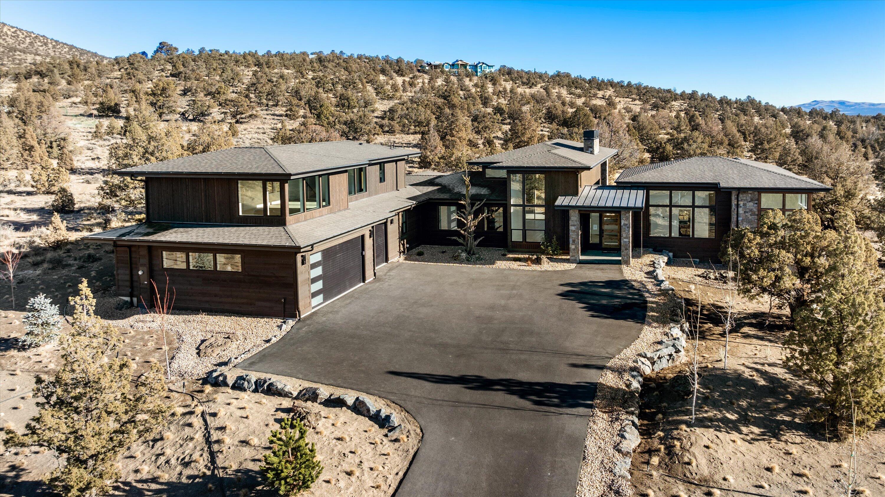 True Mountain Modern living that perfectly personifies the character of Brasada Ranch. New Construction home w/ extensive views of the majestic Cascade Mountains. Light abounds as you enter this open floor plan home which boasts a multitude of features including an open kitchen w/ a large island, stainless steel appliances, walk- in pantry, and an expansive great room that offers 16' ceilings w/ a floor to ceiling stone fireplace. The primary bedroom has private access to outdoor patio, a large walk-in closet, & spacious shower/ tub. To complete the first floor, there is an office (or bdrm), two bedrooms, full bath, & a half bath, laundry room, & oversized three-bay garage. On the second floor you will find, a loft, full bath, and a entertaining space that offers spectacular Cascade Mountain views from the windows.