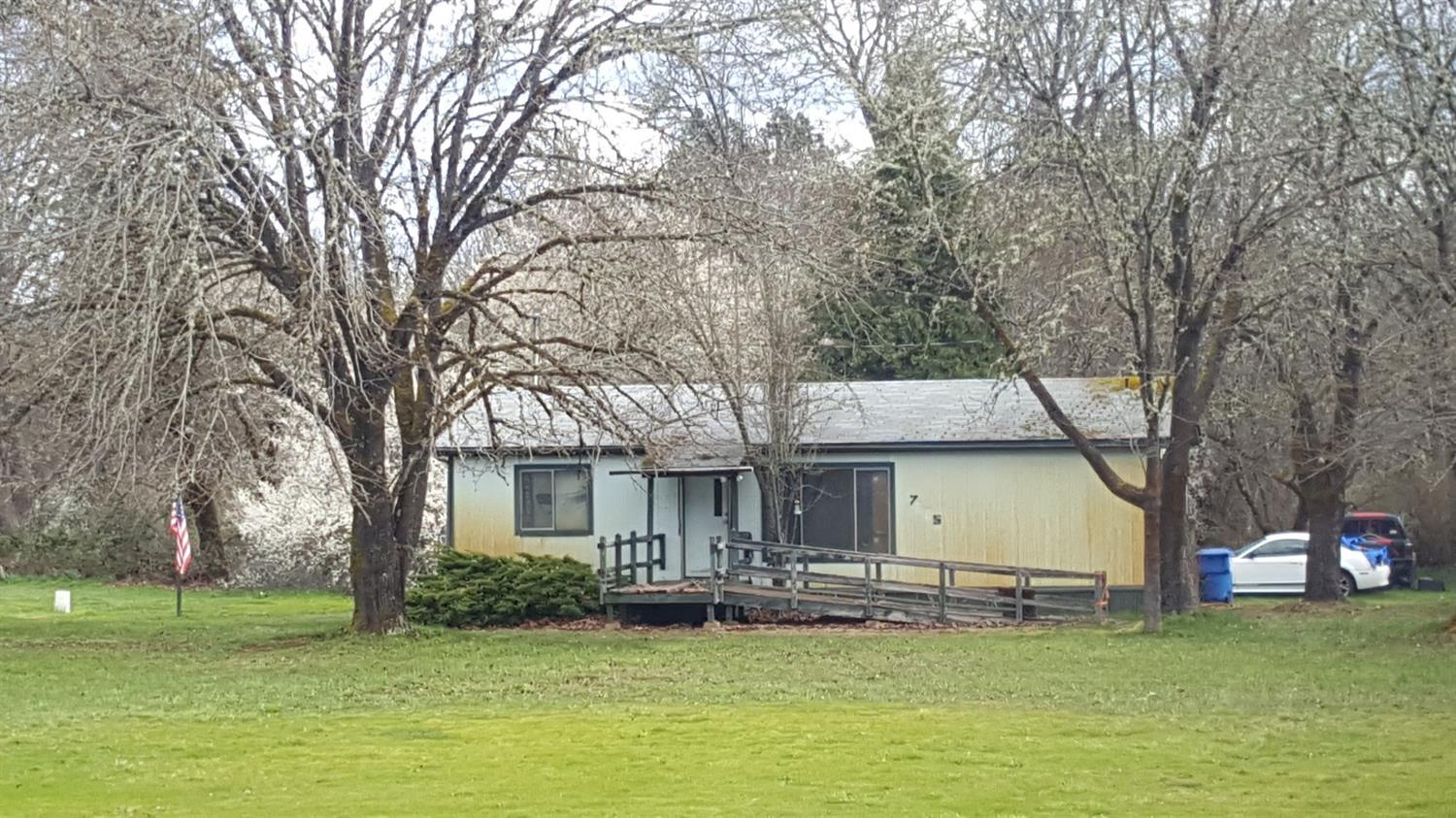 Level 5.54 plush acres along Slate Creek. Beautiful views of the mountains. Walking distance to the Wilderville market. Plenty of room for parking or building your new garage.