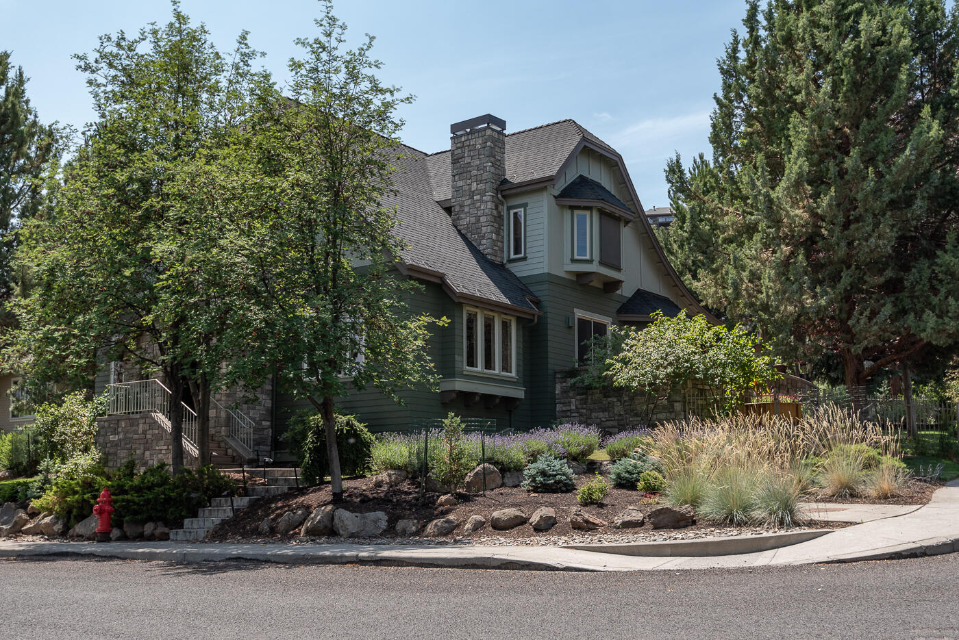 Amazing Awbrey Village home on large corner lot with attention to detail throughout! Great room with gas fireplace and built-in features. Private den off the tiled front entry. Spacious kitchen with oversized island, Wolf stove, granite slab counters, Alder hardwood flooring and box beamed ceiling with wood accents. Glass doors providing access to entertaining size deck off Dining area with Alder hardwood flooring. Double doors provide entry into Primary suite located on the main level. Primary bath features marble counters and flooring, tile walk-in shower, jetted tub, large walk-in closet and linen closet. Upstairs featuring 2 large bedrooms, full bath plus bonus room area with vaulted ceiling and beam accents. Abundant storage areas upstairs under the eaves. Beautifully landscaped yard with stamped concrete walkways and fencing. Large 3-car garage with easy alley access. Great NW Bend location in quiet neighborhood with convenient access to the Parkway, shopping and restaurants.