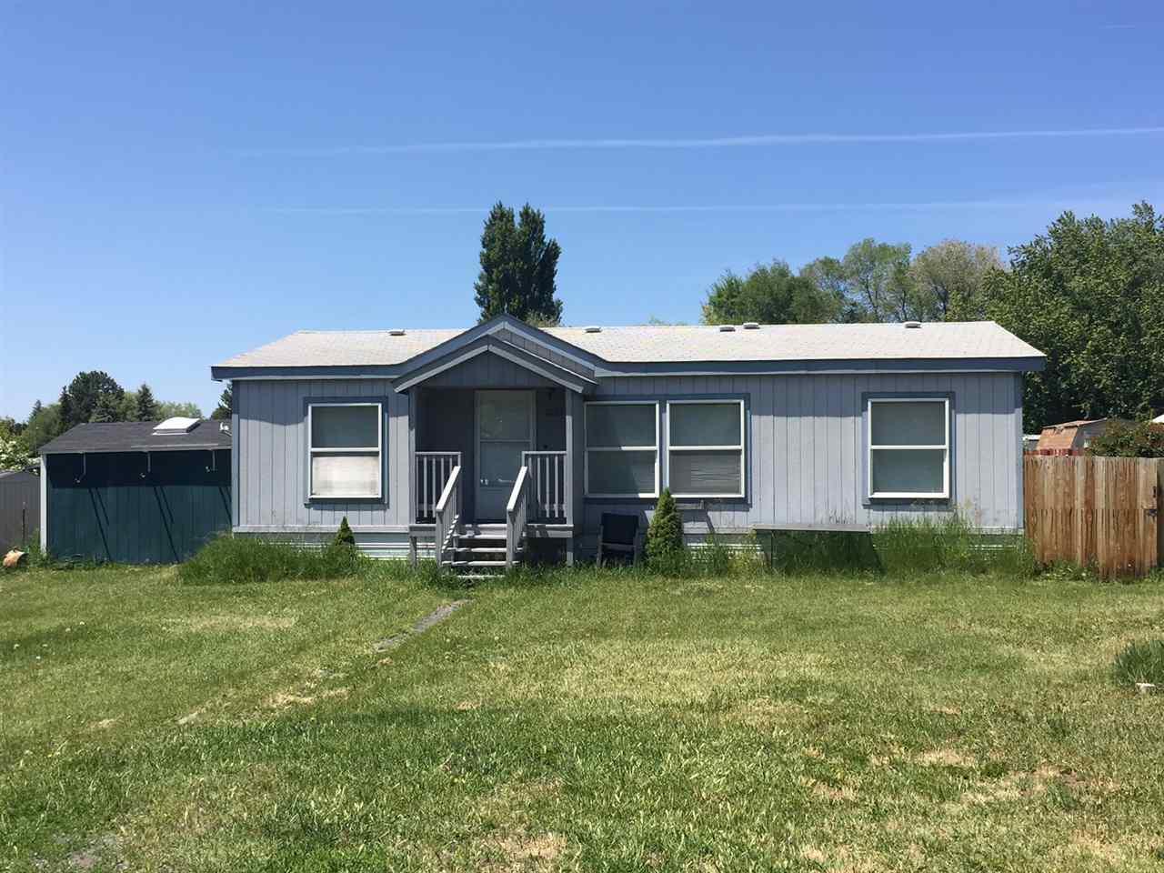 Double Wide Manufactured Home On .43 Acre. Out Buildings Include; Shop Building With Overhead Storage, Utility Shed And Garden Shed. Enterprise Irrigation Rights. Walking Distance To Grocery Store And Businesses. Split Floor Plan With A Private Master Suite, Large Bathroom And Walk In Closet. Clean And Move-in Ready!