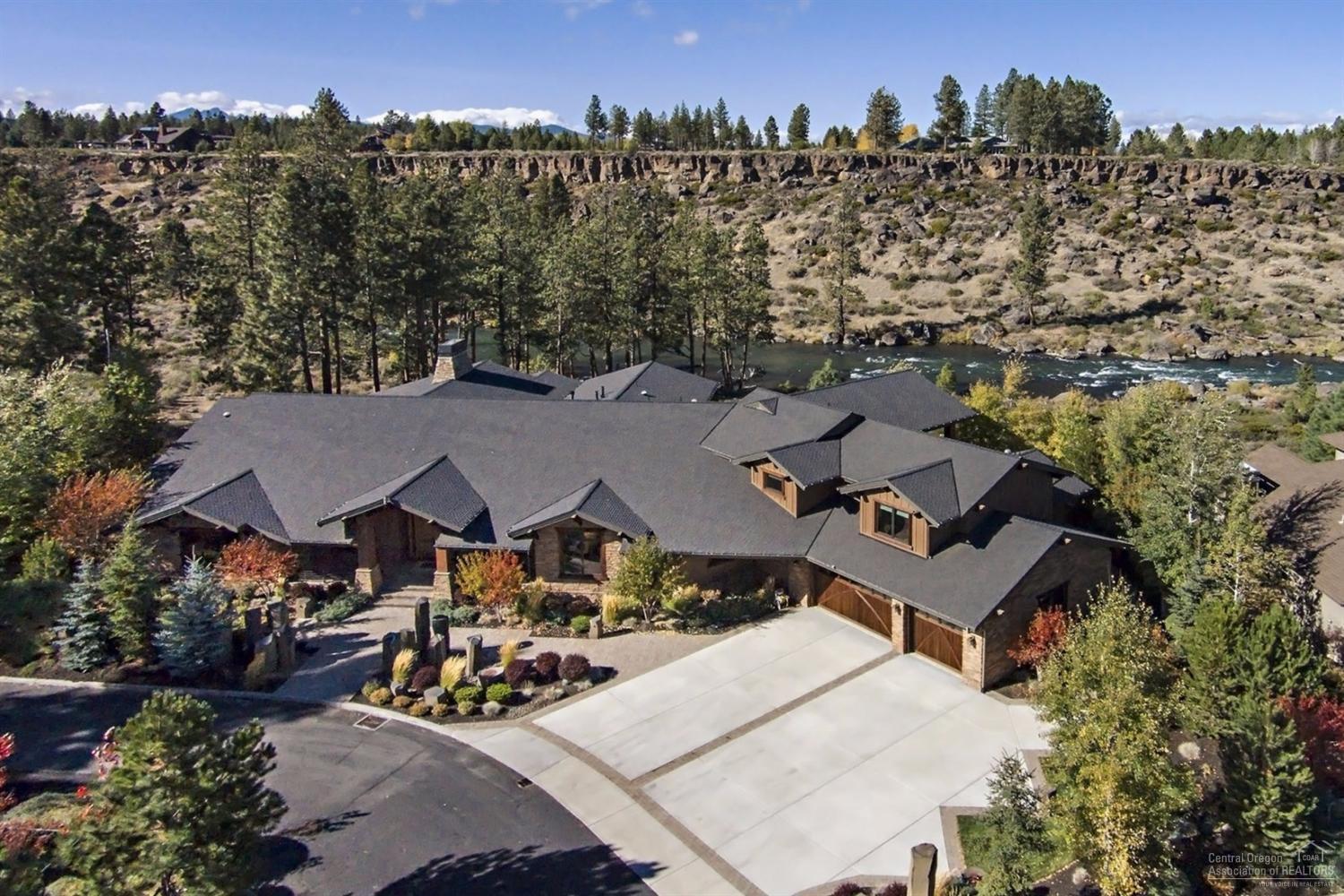 Stunning Northwest-style custom home, on two lots, with spectacular Deschutes River views. Expansive open-beamed great room with soaring stone fireplace and floor-to-ceiling windows. Gourmet kitchen is smartly designed and features slab granite counters, custom Alder cabinets, and high-end SS appliances. Main level also includes a generous master suite, executive office, formal dining, cozy family room, bonus room, and inviting bar area. Radiant floor heating throughout and wonderful outdoor spaces.