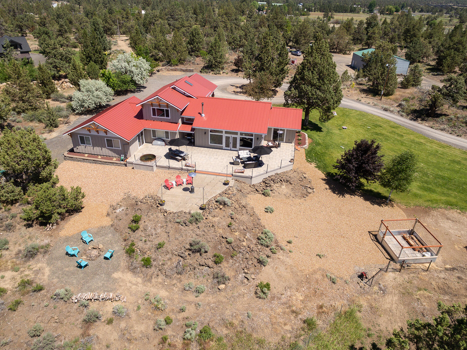 This impeccably renovated home with stunning Cascade Mountains views is just 10 minutes to both Bend and Redmond. The open great room highlights the clean lines of the home, from the oversized cement island to the dining area framed by a wall of windows. Chefs love the double ovens, gas range & abundant custom cabinetry. The office / playroom features a pocket door for taking calls in peace or hiding toys. Multi-generational option or kid haven: the bonus room flanks 2 bedrooms with a shared bath yet separate vanities. A 5th bedroom is used for crafts & music. The main floor en suite is a great alternative for the primary suite upstairs featuring a luxury bath with Japanese soaking tub & gorgeous shower. The extended patio provides al fresco dining and quality time. On nearly 10 acres, 4 acres of 24/7 irrigation creates lush pasture for hay or horses. The 48' x 40' shop, chicken coop, animal stalls & room for more complete the perfect interface between urban style & rural living.