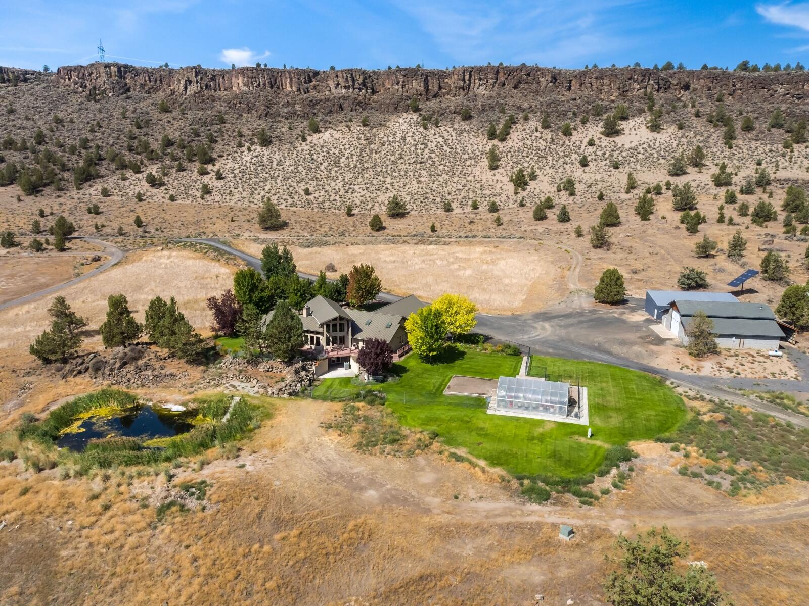 Panoramic Crooked River Valley and Ochoco Mountain Views from home on 19.8 acres at the end of the road. Custom Home is 3869 sq ft, 3 bedrooms, 3 bathrooms, main floor living, open floor plan, chef's kitchen with steam oven, breakfast bar, pantry, dining area, living room vaulted ceilings, stone fireplace with wood stove, two offices, master suite with soaking tub on main level, large utility room, bonus/media room downstairs. This home is light, bright and has quality finishes throughout the home. Wonderful outdoor living with landscaped yard, sprinkler system, mature trees and fenced yard. Property includes: 5 acres of OID water rights with sprinkler system; 2 ponds; garden; greenhouse; 52x52 insulated shop with workshop, storage, plumbed for air and wired 220; 60x30 outbuilding with 40x30 airplane hanger and gravel airstrip (750 ft). Setting is private yet close to Redmond or Prineville and ready for any Central Oregon lifestyle!
