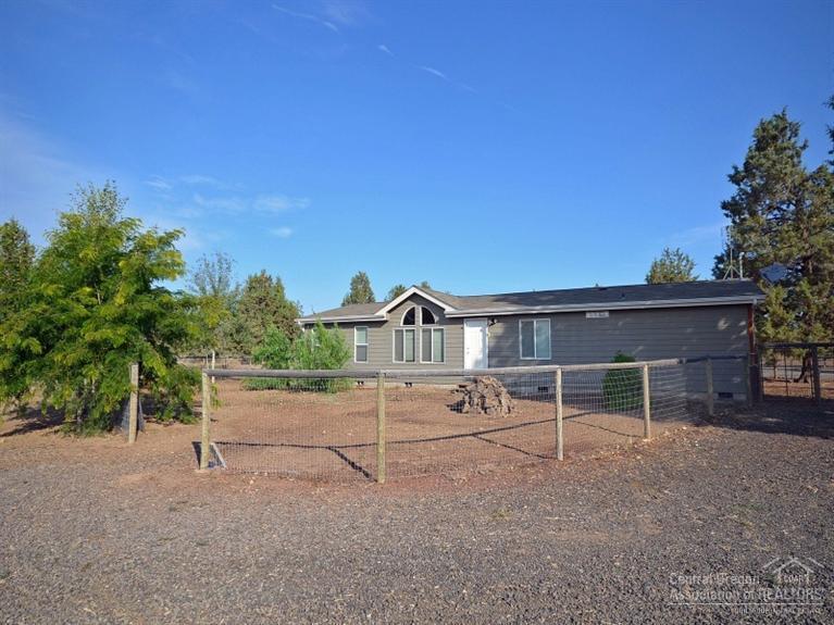 Wonderful 5+ acre ranch with newer clean manufactured home. Perfectly set up for horses with nice 2-stall barn, with insulated tack room and large bay with slide doors on each end and plenty of room for hay storage. Beautifully fenced & cross-fenced, including a fenced round pen structure and close to BLM for horseback riding. Room to roam and lots of trees to provide shade. Cascade views from many spots on the property. On community water. Enjoy all the amenities that Crooked River Ranch has to offer!