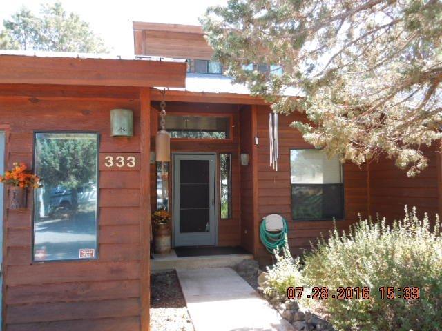 Don't miss this custom home built to enjoy views of Mt. Shasta, and Klamath Lake. Nestled on 6+ acres with mature trees and landscaping for privacy. Not to mention maintained for fire preservation, inspected and approved by Oregon Department of Forestry. Nice tile entry, vaulted ceilings with large windows providing plenty of natural light. Efficient pellet stove for the colder months, and a nice enclosed sun room off the back of the home to enjoy year-round. Featuring 3 bedrooms, 2 bathrooms, beautiful oak hardwood floors, vinyl, and tile throughout, this home has a lodge style feel. Solid oak interior doors and insulated steel exterior doors. The master is very spacious with double walk-in closets and large bathroom. The kitchen is open to the dining room with a nice breakfast bar and large pantry with illuminated work space. Huge oversized garage off of the laundry room, wired for 220, pull down insulated attic storage above, as well as, shelving below and nice workbench area. There