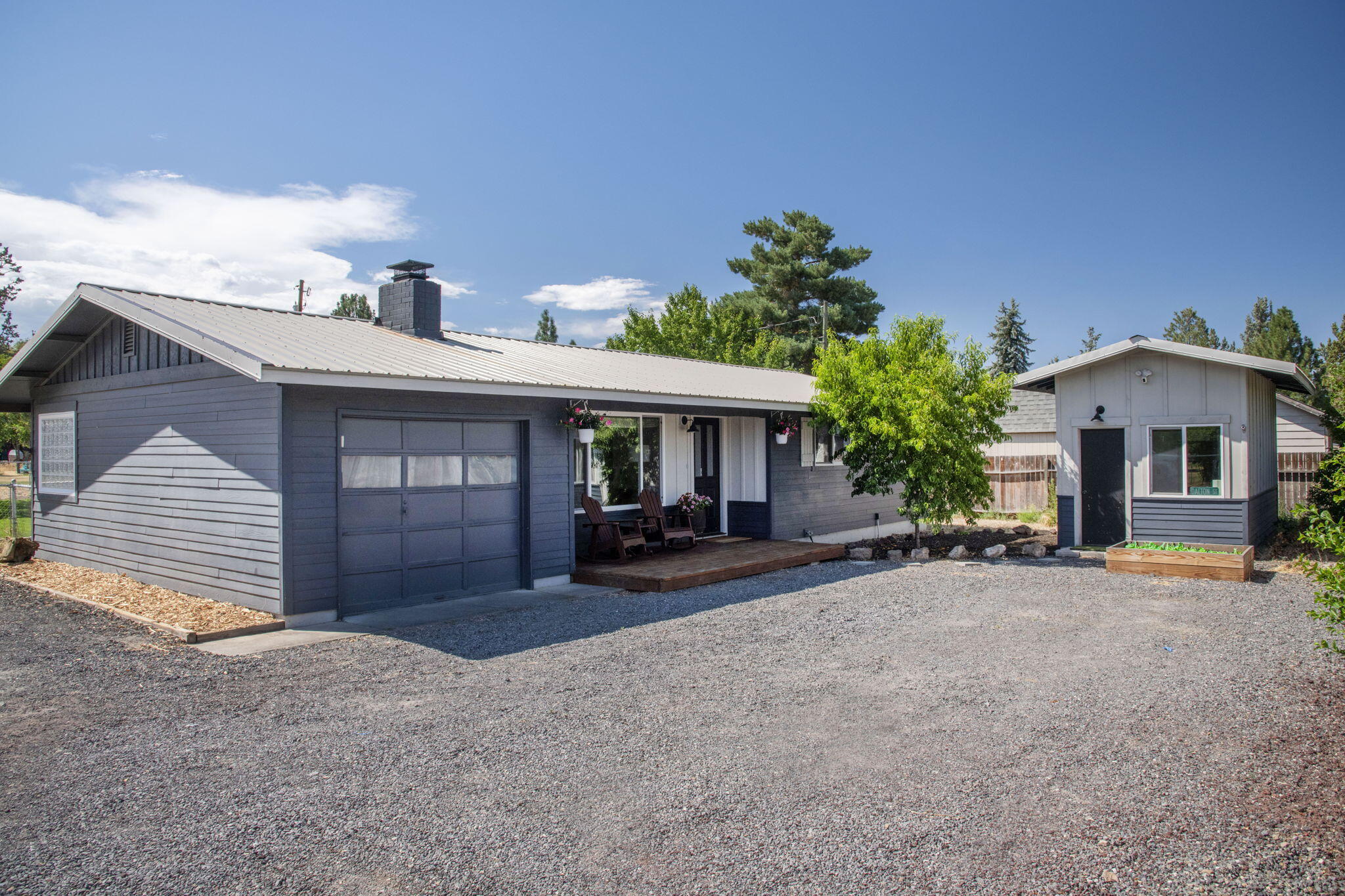 This nicely updated home situated on a huge, level lot features plenty of RV parking with an 220 volt hookup.  The home is darling- with brand new laminate wood-like flooring, 24'' tiled countertops, a coffee nook, wainscoting in one of the three bedrooms, beautifully updated bathroom with a gorgeous vanity and sconces. The detached shop, currently used as a gym, is finished, heated, with two windows provide a light and bright space, could be whatever you need- home office, extra bedroom, workspace, etc. So much to offer here at this conveniently close-in SW Redmond location (just 12 minutes from the north end of Bend and 5 minutes to the airport).  A definite must see, it's dialed and ready for it's new owner!