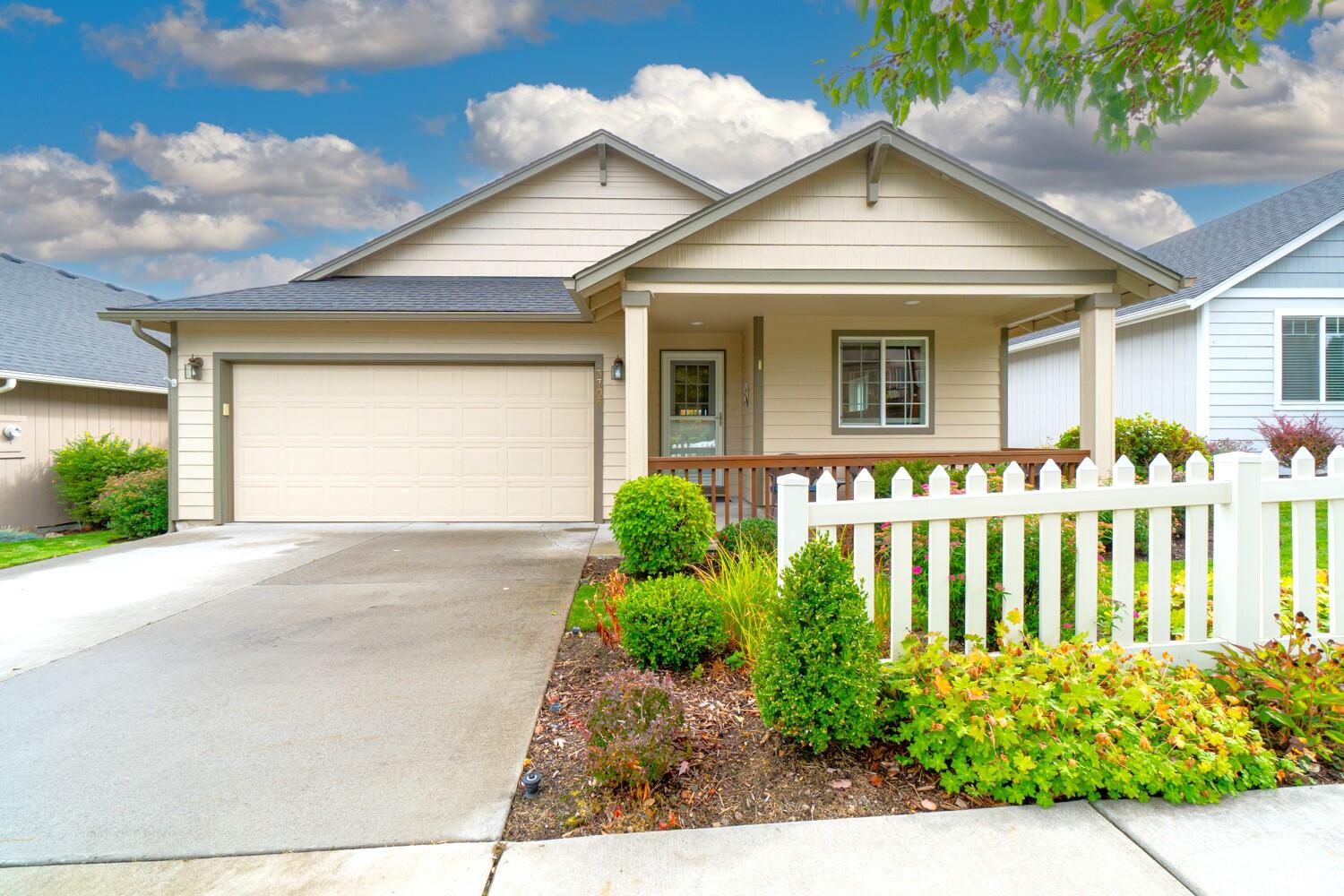 Located in SW Redmond within the desirable Summer Creek community, a 55+ neighborhood filled w/cottage style homes. This great room floorplan ftrs vaulted ceilings, large picturesque windows for an abundance of natural light, & a cozy corner gas burning fireplace w/hearth & mantle. Kitchen ftrs a central island w/double sided sink, an abundance of cabinetry & prep space, under cabinet lighting, a large corner pantry, built-in desk space, plus a large dining area w/sliding doors to lead outside to deck. Large vaulted primary suite w/walk-in closet, double vanities, step-in shower, & enclosed water closet. Two additional well appointed guest suites share a full bath, one serving as a home office currently. Large laundry room w/plenty of space for additional storage options. Gorgeous landscaping in the front/backyard w/a covered front patio & open back deck as well. Located right across from open community space & a short distance away from the Clubhouse.