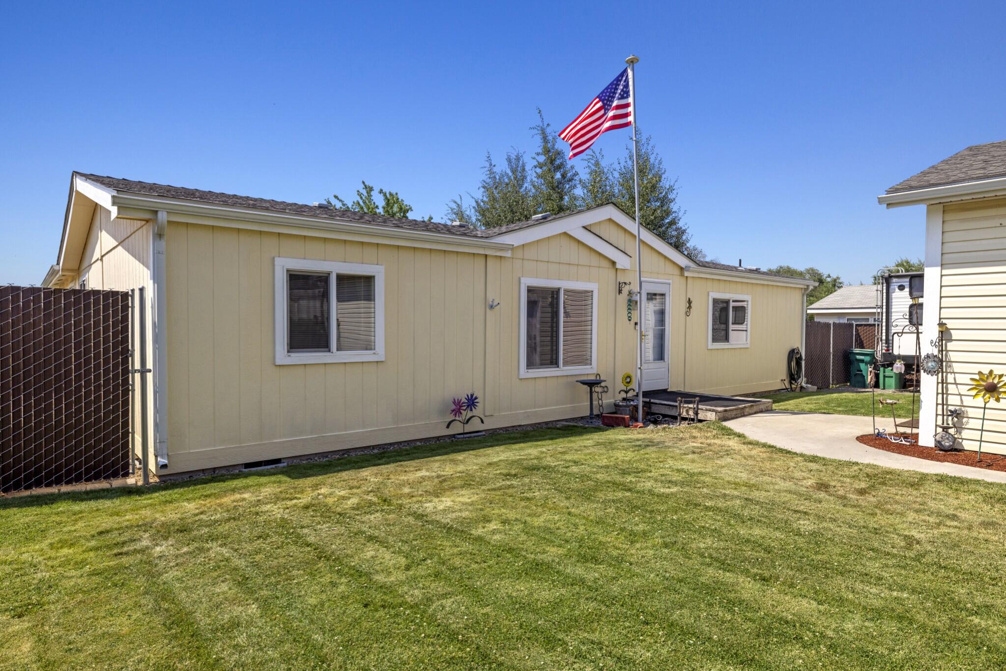 Don't let the ''manufactured house'' term keep you from viewing this beautiful, well-maintained home. Walking into this home immediately shows pride of ownership; the open-concept, split floor plan provides privacy for the primary suite and the 21'x22' addition of two sizable bedrooms, and a storage closet provides ample room for a large family or multi-family living. The backyard is a little paradise with a paver patio, gorgeous trees and lawn, and 600' of privacy fencing and there are inground sprinklers in front and back. The two-car detached garage is 24'x24' with full electric, two 220, 30 amp outlets and heaters; RV parking is available too! So many recent upgrades...central air/heat pump, fencing, water heater, fascia and gutters, vinyl double pane windows, and roof. Please review all property information and make your appointment today!