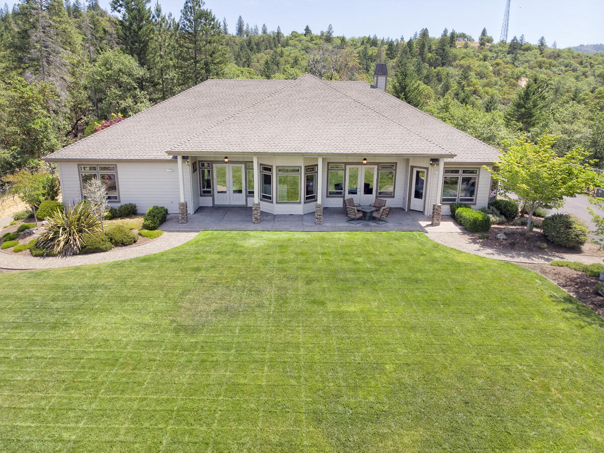 This 4315sf retreat/residence sits on 5 private acres with gorgeous mountain views. It's grand 8' entry doors invite you into exquisite living spaces of vaulted ceilings, a stacked stone fireplace & scraped hardwood floors. The entryway leads you to the anchor of the home where the well appointed kitchen with granite counters, center island, wine cooler, gas cooktop with double convection wall oven and stainless appliances awaits. You can't avoid being captured by the floor to ceiling windows in the surrounding living/family rooms offering up a canvas that stretches to the sky.  With 4 bedrooms and an addt'l room as den or office, the master suite is elegant with built-in cabinetry, gas fireplace, large bath area w/custom stone & tile shower. Upstairs spacious loft.  Finished 3 car garage, with epoxy layered floors, 220V power, 400 amps & RV parking. The property is fully fenced with a security system network and just a short drive to all amenities. Too much to list, much more to see!