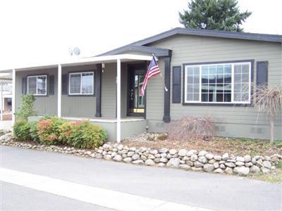 Located in Whispering Pines Manufactured Home Park! Vacant & ready for immediate occupancy. This 1998 built triplewide home is 2016 sf., large floor plan, quiet area, large back deck with hot tub, pond and nicely landscaped. Reliable community water system. Very clean park. Home is on a cul-de-sac at west side of park. Must See!