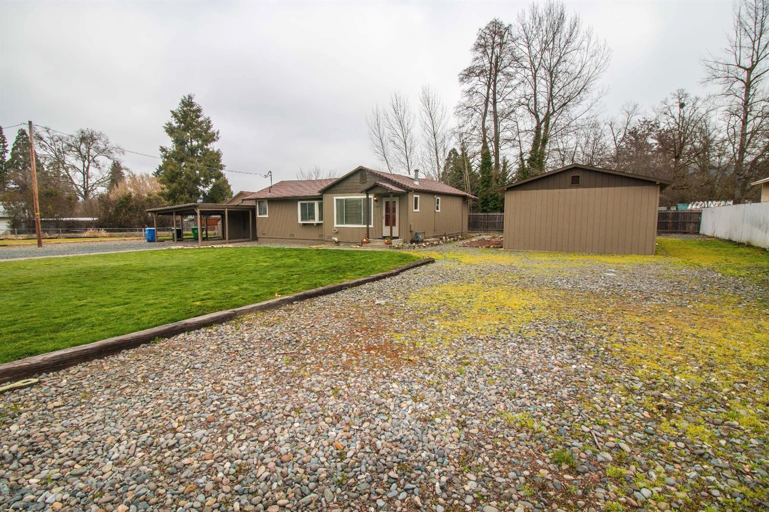 Charming updated home on over half acre and fully fenced. Just minutes from town, hospital, parks and schools. Great open floor plan for entertaining. Nice updated carpet, tile and laminate flooring throughout with cozy gas fireplace. Enjoy the private deck off of the master bedroom with hot tub possibilities. Detached 2 car carport with attached shop with an additional 34 x 17 shop. Bonus RV parking and room for a garden. Priced to sell!