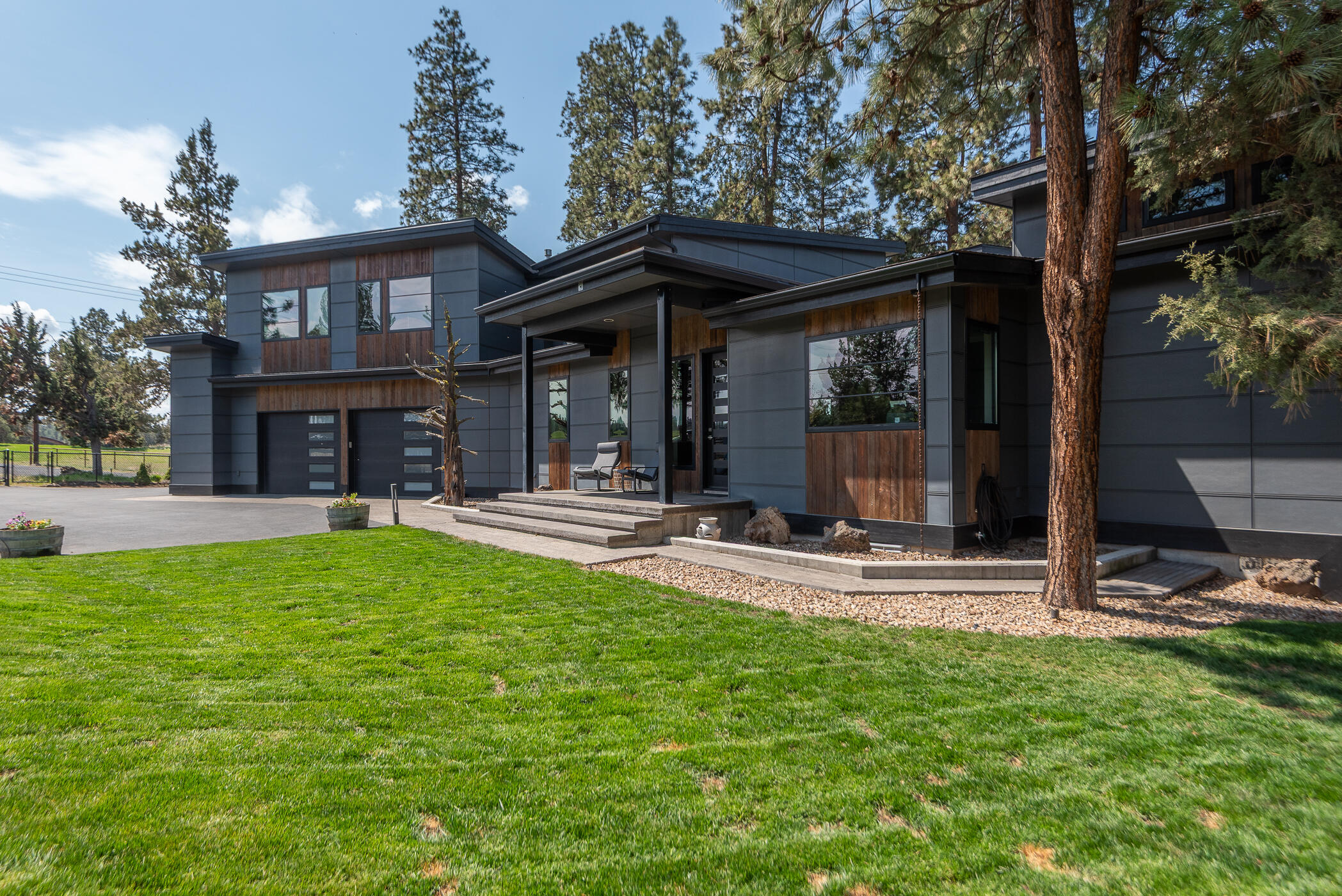 Modern Escape on 4.8 Acres - Development Potential & Income-Producing Extras. Discover the perfect blend of style, function, and opportunity in this 3,361 sq ft home,built in 2018, 3bd+office/2.5ba residence showcases sleek concrete floors, high ceilings, and walls of windows that flood the home with natural light and frame breathtaking mountain views. Effortless indoor-outdoor living, glass-paneled overhead doors open from both the living area and lux primary to a heated deckâ€”ideal for taking in vibrant sunsets and stargazing. Kitchen is a showstopper w/expansive prep and gathering space +separate side bar area w/2nd dishwasher, sink, disposal, & beverage fridge. Add'l features include: Radiant heated floors in kitchen & primary bath, Stunning mud rm finished oversized attached garage, Durable Hardie siding, 30-year comp roof, and natural gas appliances. Bonus income potential abounds with a 1,280 sq ft guest house/ADU, a 44'x20' shop, and pasture area now generating rental income.