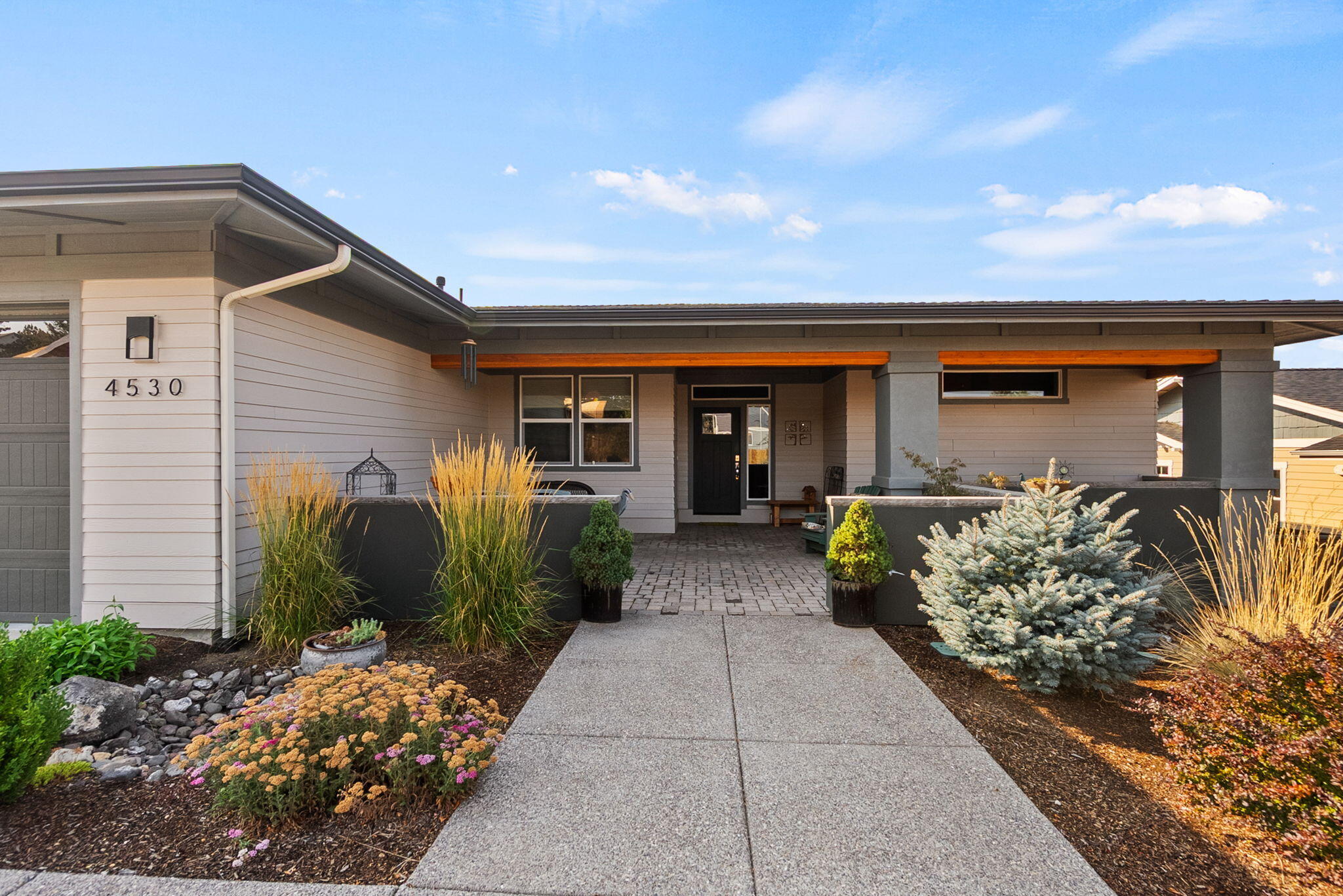 Light-filled, single level mid-century modern design meets easy living in this beautifully maintained Redmond home for sale, set on a generous .24-acre lot with mountain views. The open living space is ideal for gathering and entertaining, with large windows, great flow, and a seamless connection to the covered back patio. Enjoy peaceful mornings and evening sunsets with views that bring the outdoors in. The kitchen features quartz countertops, a large island, and abundant storage—perfect for everyday living and hosting. The primary suite offers privacy with a spacious walk-in closet and tiled shower, while the secondary bedrooms are well-sized and thoughtfully separated. A three-car garage with epoxy floors provides room for vehicles and gear, plus RV parking and a charming studio ''she shed'' in the backyard for work, hobbies, or quiet retreat. Well cared for and move-in ready, this home offers comfort, flexibility, and space in a sought-after pocket of SW Redmond.