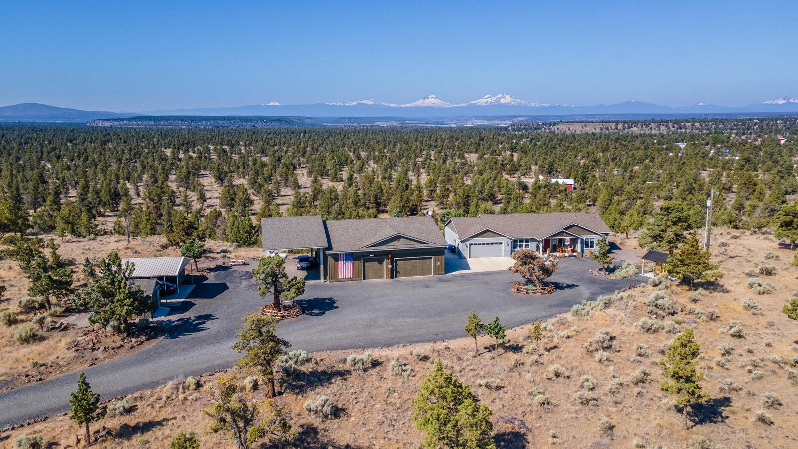 Incredible opportunity to own a turn-key, ADA accessible custom home on over 5 private acres with unobstructed Cascade Mountain views! Enjoy the spacious deck with or step down to the covered hot tub for a panoramic view, Also views  This well-maintained property features a spacious 3-bed, 2-bath home, a nearly 2,000 sq ft shop built in 2016 including its own bathroom. Plenty of space for toys and direct access to BLM land—offering privacy, peace, and recreation right out your back door. Ideal for hobbyists, or anyone seeking flexible living space with no compromises. All major systems in place including well, septic, and paved driveway, full RV hookups as well! Check out new County rules for ADU opportunity (Buyer due diligence)!!! Located in Crooked River Ranch with access to golf, trails, tennis, and more.