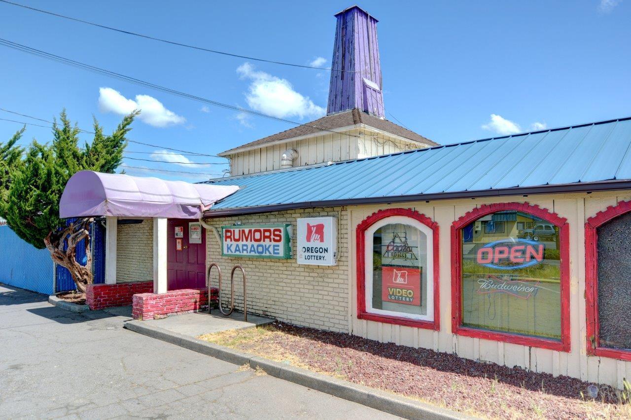 Over 7500 Square Feet and a large .99 acre lot on a signalized intersection in the heart of Medford.  This business is operating currently as a bar and grill that also offers Oregon State Lottery that earns handsome commissions for the owners.  There are 2 separate tax lots and the building is configured for more than one occupant within the space.  The unoccupied second space was most recently a restaurant.  This operation is sold with the business and the real estate.  Hurry, this is priced below the assessed value of the real estate alone!