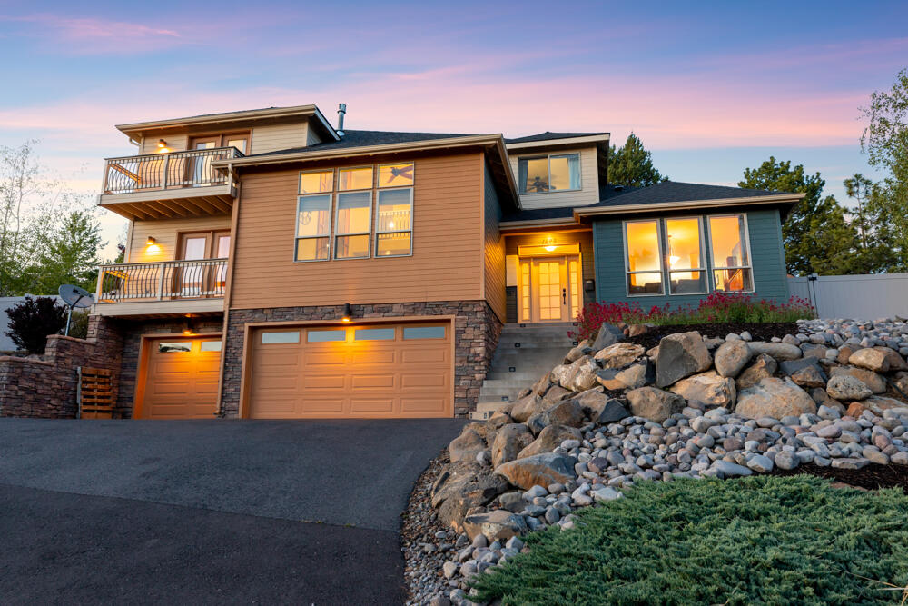 Custom contemporary home in the desirable Hot Springs area! Located just minutes from the Hospital, OIT, and Downtown Klamath Falls. Featuring an open floor plan with vaulted ceilings in the living room & a gas fireplace, plus bonus room, formal & informal dining. The spacious kitchen provides granite counters, stainless appliances, pantry & an island with gas cooktop & bar seating. The primary suite boasts its own private balcony, soaking tub & a great walk-in closet. Relax or entertain on the back patio & take in all the beauty this yard has to offer, including a soothing water feature. Terraced landscaping with sprinklers, raised garden beds, gazebo, deck with views, greenhouse & hot tub ready patio area. Built-in speakers wired for sound both inside & out. Abundant storage in walk-in attic & basement area with 3 car garage, plus gas forced air heat & AC. Additional nearby attractions include a paved path/ biking trail, dog park & community park. This home is one of a kind