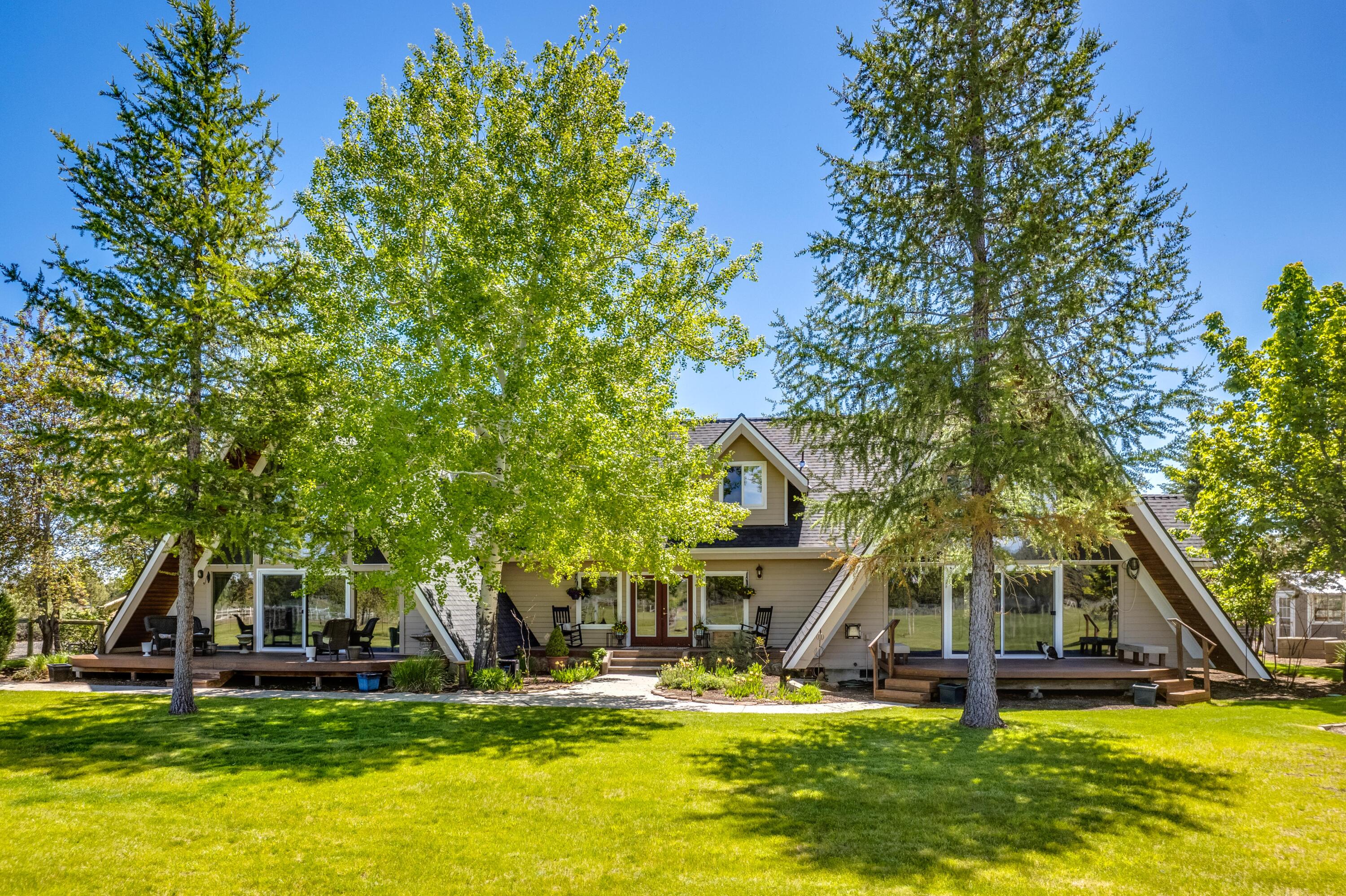 Take in the peace and quiet while enjoying the sun setting over the Cascade Mountains from this beautifully remodeled modern farmhouse on 8.49 acres.  Everything in this home has been touched!  Enjoy the soaring high ceilings in this double A frame home with hardwood floors throughout main level, updated kitchen with all new SS appliances, new carpet in all bedrooms, all bathrooms have been remodeled, new roof on both home and shop, and much more!  Featuring two primary suites on the main level, additional bedroom upstairs and a HUGE 4th/Bonus room with walk in closet over the garage.  Gorgeous property with 2.5 acres of irrigation, fenced pasture with underground sprinklers, shop/barn with 4 stalls, potting shed & raised beds plus a chicken coop. This would make a great home for multigenerational living if needed!  
Wine & Cheese Open House Friday 3-5 and Open House Saturday 1-3.
