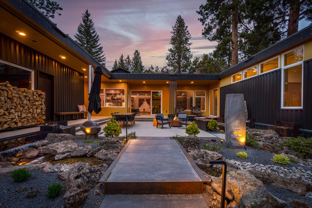This architectural masterpiece sits on Bend's storied ''Doctors' Row'' coveted by locals for its rich history, towering pines and unique take on modern mountain living. Designed to meld harmoniously with nature, this single level refuge exudes a thoroughly modern aesthetic.The open living area blends seamlessly with a central courtyard made private by a Gabion rock wall and made peaceful by the sound of water flowing through a meandering path of reflective pools and integrated falls. Blessed with year round sun & its southern orientation, the courtyard is as idyllic as it is functional, including custom metal seating and design accents, as well as a locally crafted, nordic spruce lined sauna. Passive solar, radiant heat, Triple E windows and a HEPA filtration air system allow for clean, low maintenance living. The fully finished, heated garage is just as beautiful with gear storage and ample project space. Distinctive, refined, and tranquil, this home embodies Bend living at its best.