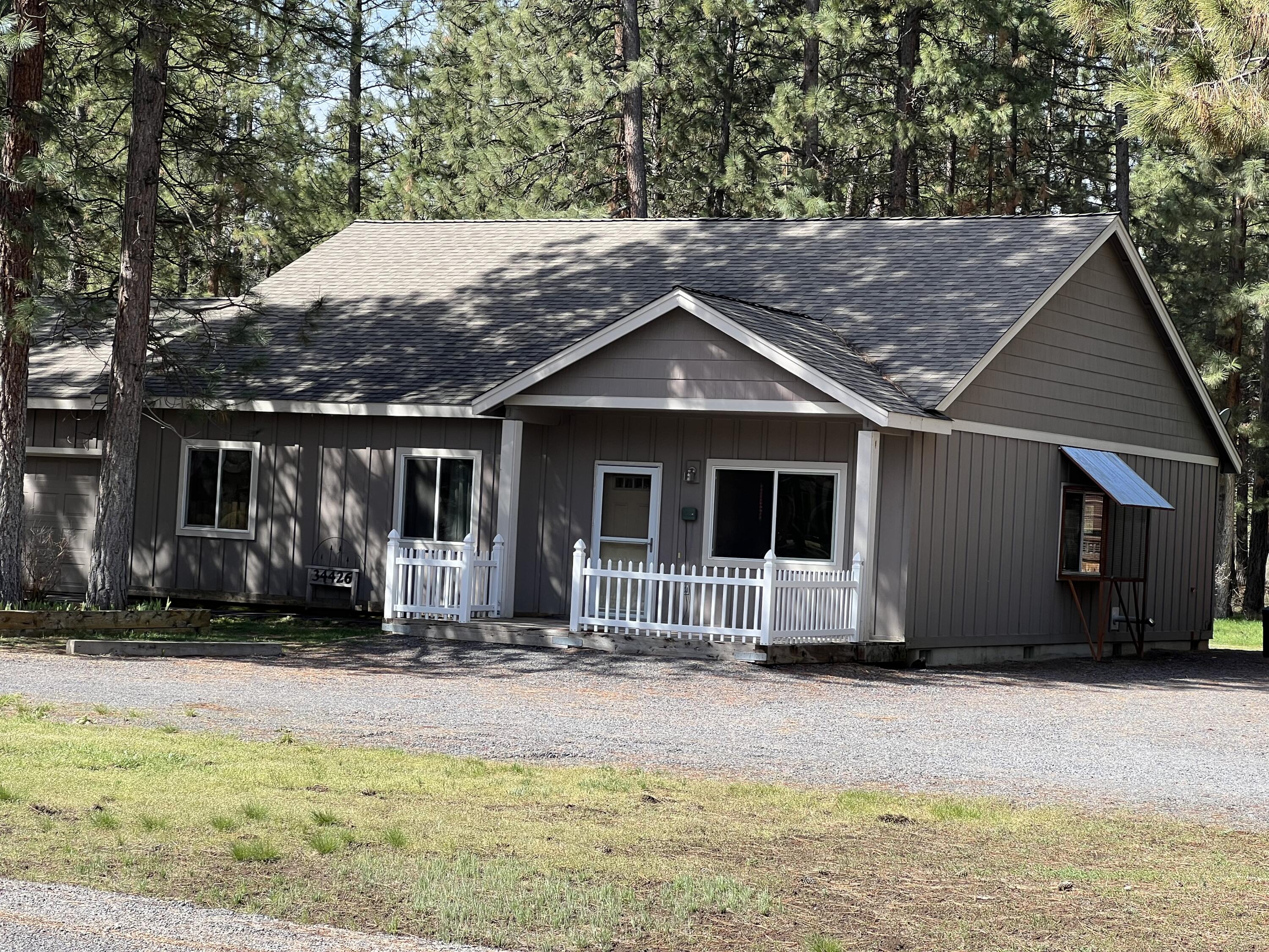 Beautiful home nestled among the pines. Situated on 2 acres in the esteemed Pine Meadow Village, an impeccably paved nice subdivision. This single-owner property spans 1807 square feet featuring 3 bedrooms / 2 bathrooms, attached 484-SF garage equipped w/automatic door opener, a detached car port, 3 additional outbuildings. Primary bedroom is very large w walk-in closet. Kitchen boasts tile counter tops, breakfast bar and a walk-in pantry. A NEW Durastar Heat Pump installed fall-2023 leading to fantastic efficiency with low power bills. Septic professionally serviced (1000 gal) Oct 2023. Equipped w/inside sprinkler system, vinal windows and nice appliances -all included. Ample parking options plus 2 entries on a circular drive. This neighborhood is sought after with all stick built nice homes, conveniently located just minutes to Crater Lake, Southern Oregon's finest fishing/Kayaking Rivers and endless hiking trails, such as Mt McLoughlin and others in the Cascade Mountain Range.