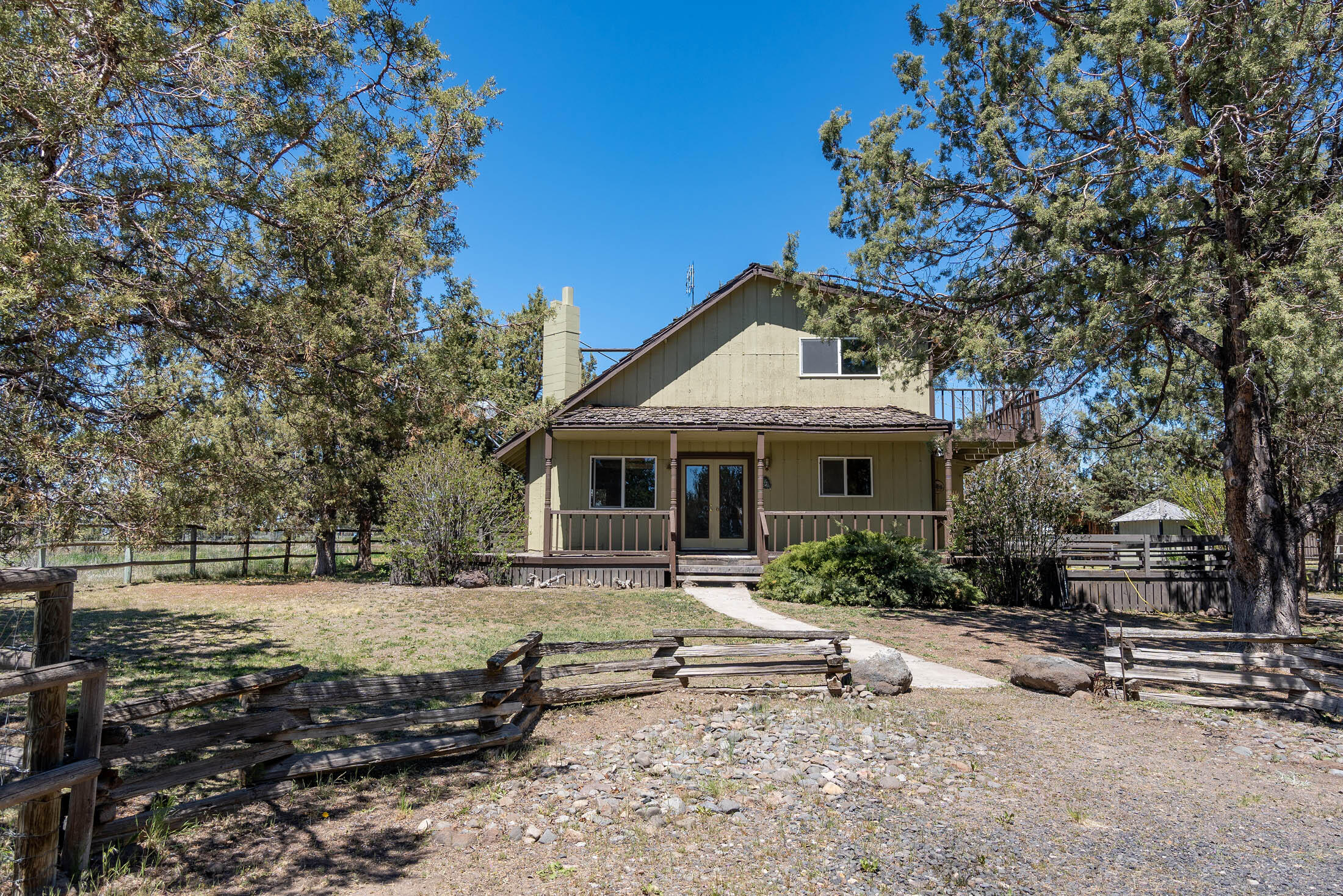 Your opportunity to own 10 acres in the country with privacy and Cascade Mt. Views. Private circular drive leads you to this secluded Tri-level, 1625 Sq Ft home built in 1978 w/ dbl attached garage. Main floor includes; large open vaulted great room with wood beamed ceilings, rock hearth w/pellet stove, kitchen, eating bar, pantry, dining area, utility, large bedroom and guest bath. Vaulted open loft area on upper level with two additional bedrooms, including primary w/ bath and private deck. Unfinished basement area has some framing and wood stove. Fenced and cross fenced, private well, large barn, stalls, hay storage and pens ready for your animals plus intriguing wood shop building w/ loft area, two storage sheds and poultry facility which provide numerous options for a mini farm. Property is two tax lots, potential to build additional dwelling! Buyer's to verify with county. Short distance from town, schools and hospital.