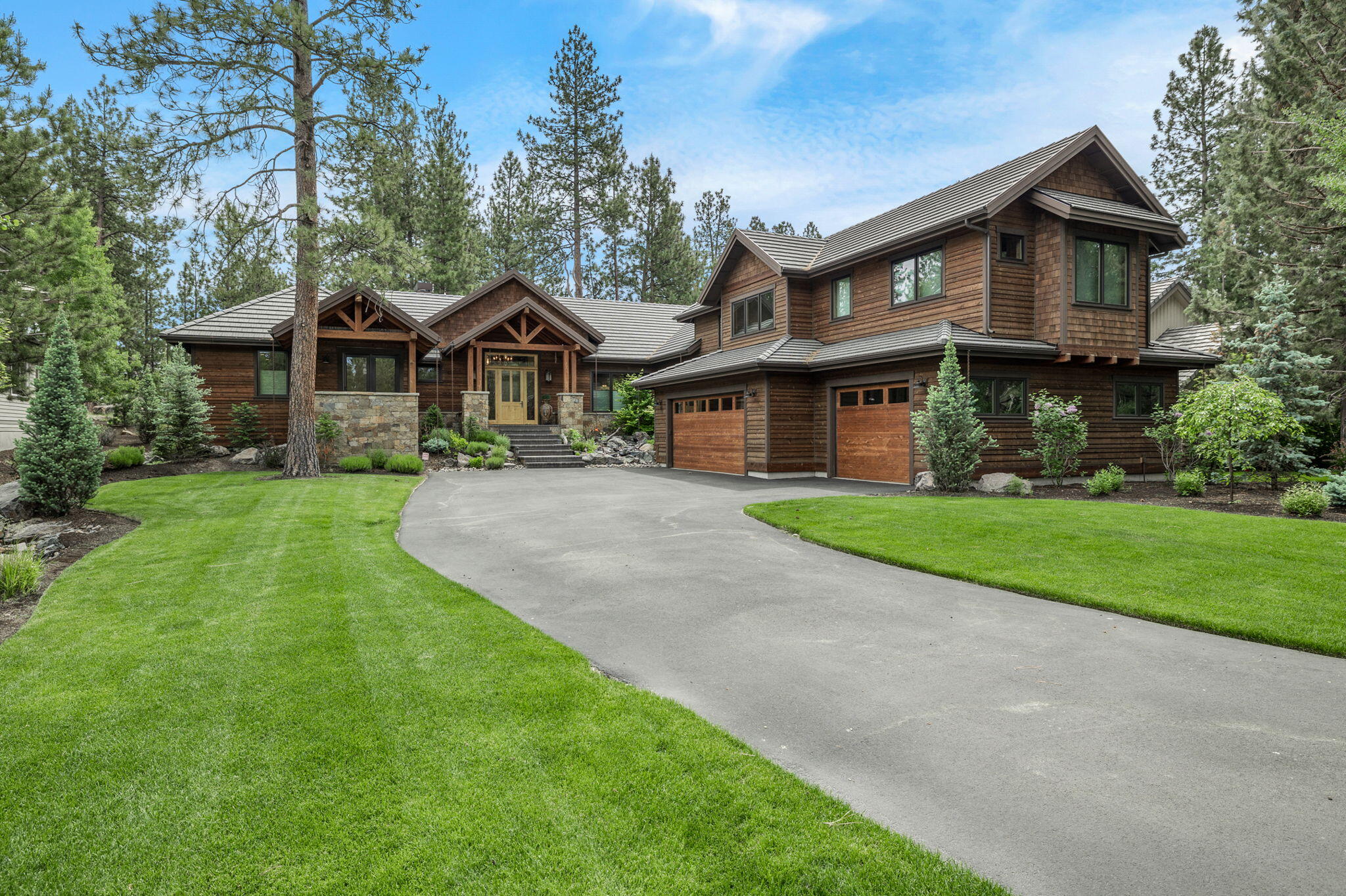 Casually elegant Broken Top home in an especially peaceful & private location along the first fairway. Cascading waterfall at front entry leads to interiors combining a mountain chalet influence with a fresh contemporary aesthetic. Crystal chandeliers paired w/rustic beams & stone encased fireplace in great room enhance landscape & fairway views. Kitchen showcases top-of-the line Miele appliances, an expansive island/brkfst bar, Butler's pantry w/ wine & professional sized refrigerators & dining area overlooking front waterfall. Outdoor kitchen on heated patio, overlooking backyard, is perfect venue for al fresco entertaining. Serene main level primary suite, w/hot-tub patio, luxurious bath w/ freestanding tub, marble tiled shower & sitting room (or Pilates studio, study, 2nd walk-in closet). Main level also encompasses private office & a cozy family room w/ fireplace & access to backyard. Second level offers a second primary suite, full en-suite guest room & loft w/ built-in daybed.