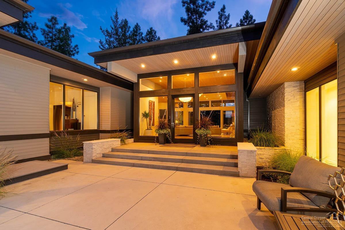 Stunning modern custom home with golf course and Cascade Mountain Views designed by Eric Meglasson and built by High Timber. With expansive windows and large sliding doors, this home lives beautifully with abundant natural light and contemporary twists showcasing cedar ceilings & white oak floors. The spacious kitchen showcases a white quartz island with water fall edge, seating for brunch or cocktails. Concealed appliances and double layer drawers provides a clean and modern feel. Elegant and whimsical lighting, built-in retractable television in the great room, blackout blinds in bedrooms, wool carpet in the bonus room and Jr en-suite with private entrance from the courtyard will charm. Master suite with private terrace en-suite with waterfall soaking tub is a spa like experience. Outside living in the private sanctuary of the front courtyard or back terrace with expansive views with a fire pit for nightfall will entice one to experience the breathtaking beauty of the high desert.